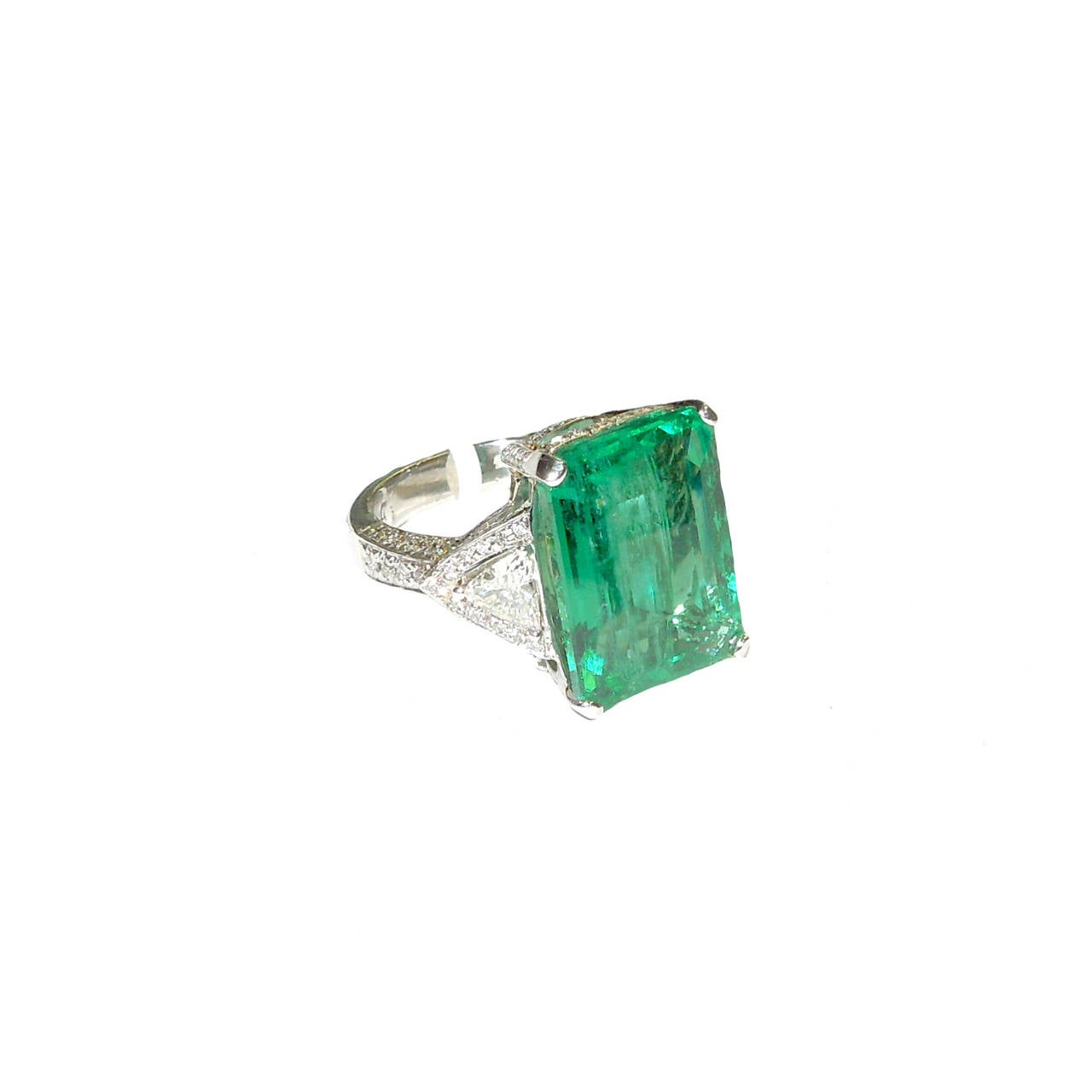 11.92 ct. Zambian Emerald Ring

2- H Color, VS Quality Trillion Diamonds 1.00 ct. (0.50 each)  

0.60 ct. round diamonds

Ring is made in Platinium.

Zambian Emerald comes with Certificate, very clean stone. 

Ring can be sized up or down,
