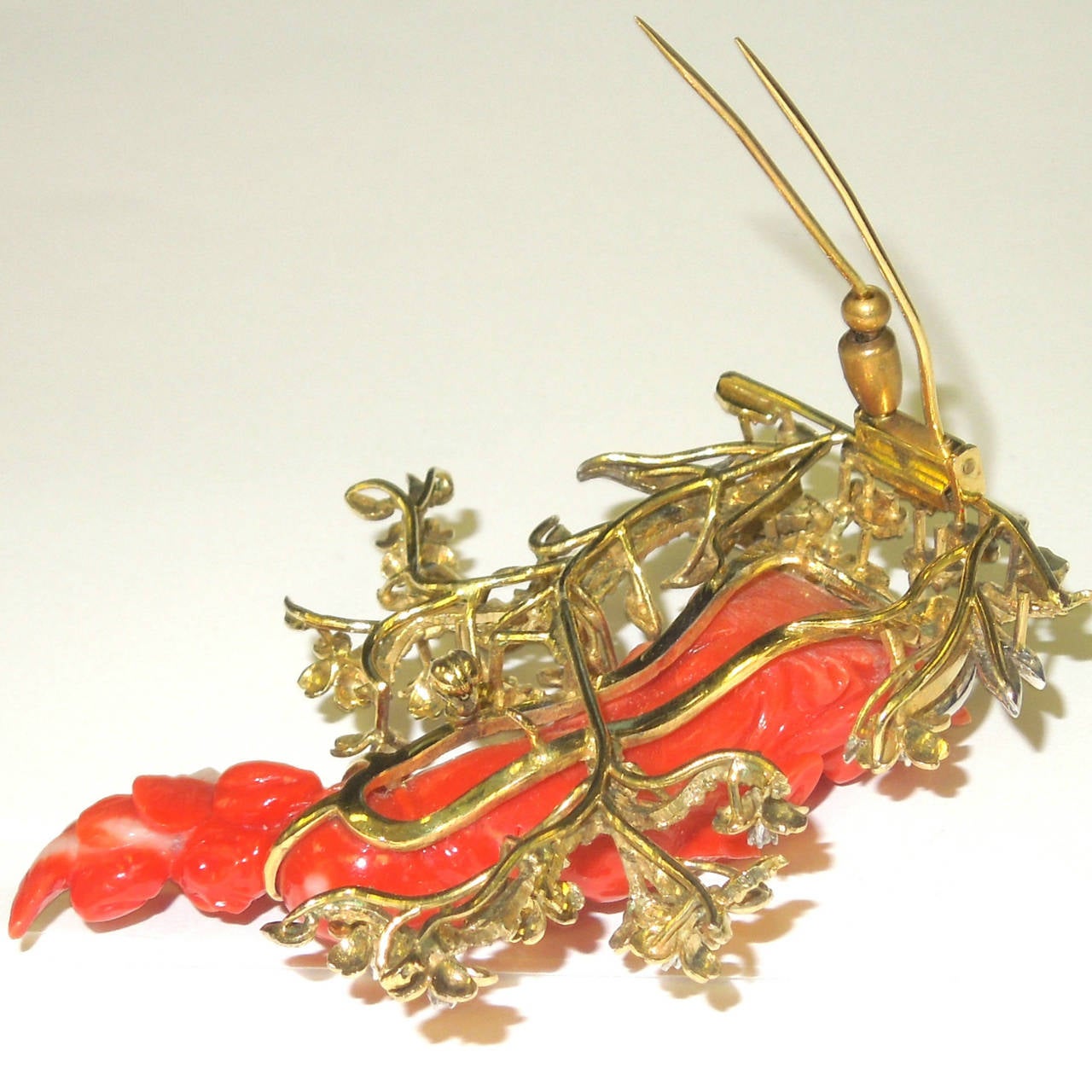 18K Gold Pin with special carved Coral center & diamonds

Coral measures 2.8 inches in length X 0.75 inches in width

0.45 ct.'s of G Color VS Quality Diamonds are set in the flowers around the pin

Pin opens and closes with double