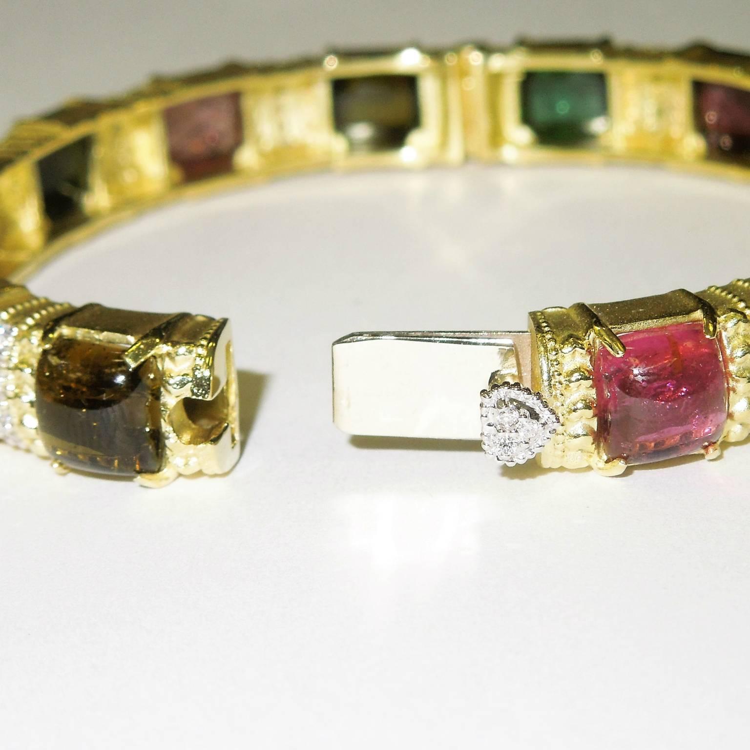 18K gold bangle bracelet with tourmalines and diamonds

Diamonds and tourmalines go all the way around

23.00ct. total multi-color tourmalines, 7mm each.

0.63ct. G color, VS Clarity diamonds

0.30 inches in width

Signed STAMBOLIAN with our