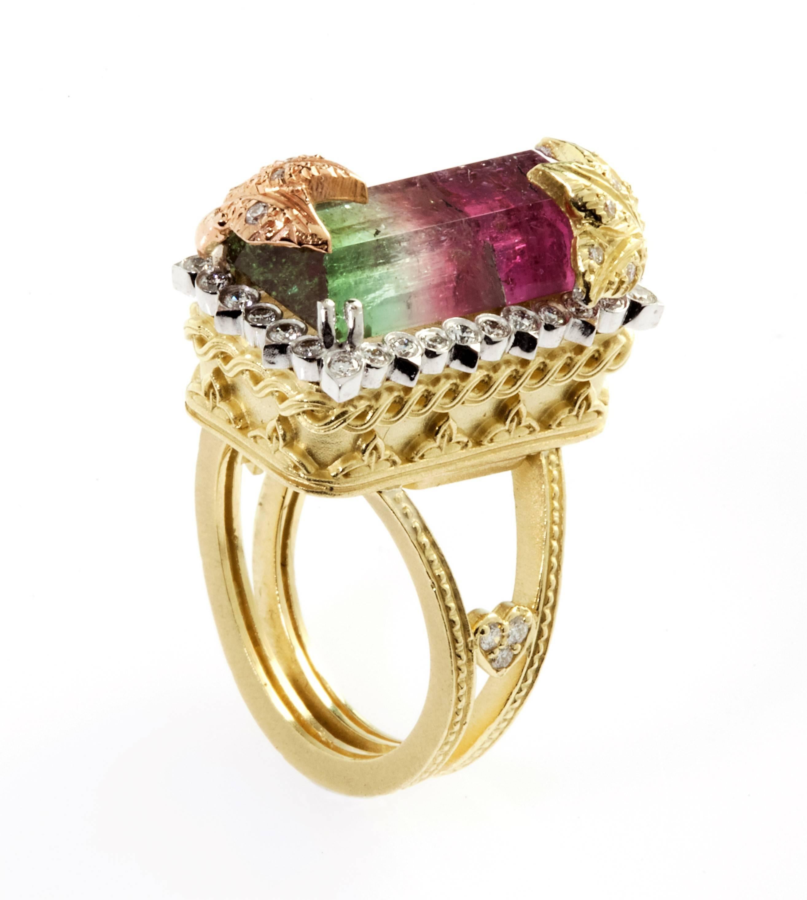 18K Tri-Color Gold Ring with Watermelon Tourmaline Center surrounded by diamonds  

9.56ct. Watermelon Tourmaline Center, above two corners are pink and yellow gold with diamonds, floral design work.  

Watermelon Tourmaline 18mm x 9mm. 