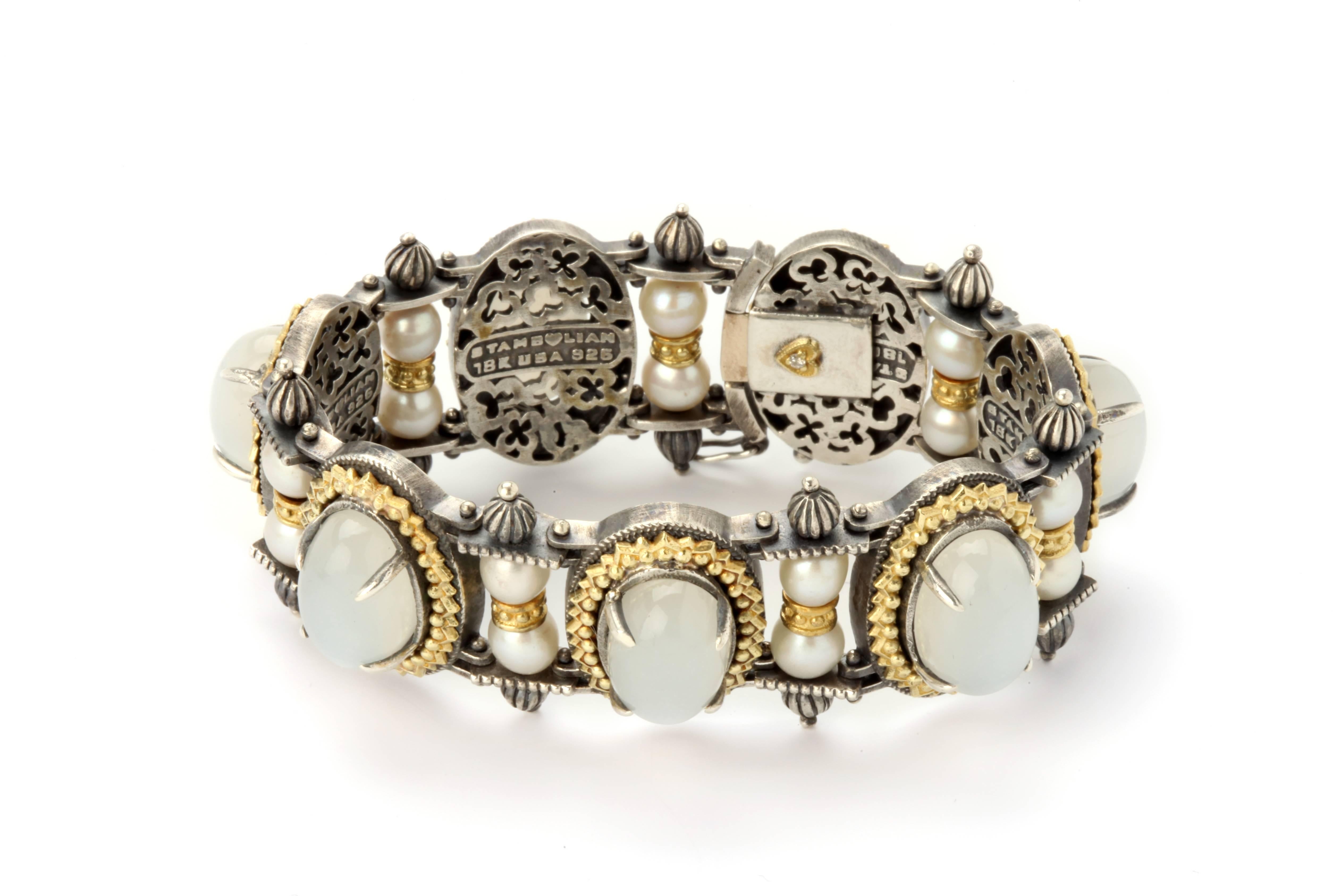 Aged Silver & 18k Gold Bracelet with Moonstones and pearls

53 ct. Moonstones, 7 total
 
In between each section is a pair of pearls 

7 inches in length
1 inch wide

Push Botton Clasp

Signed STAMBOLIAN with our Trademark "Diamond