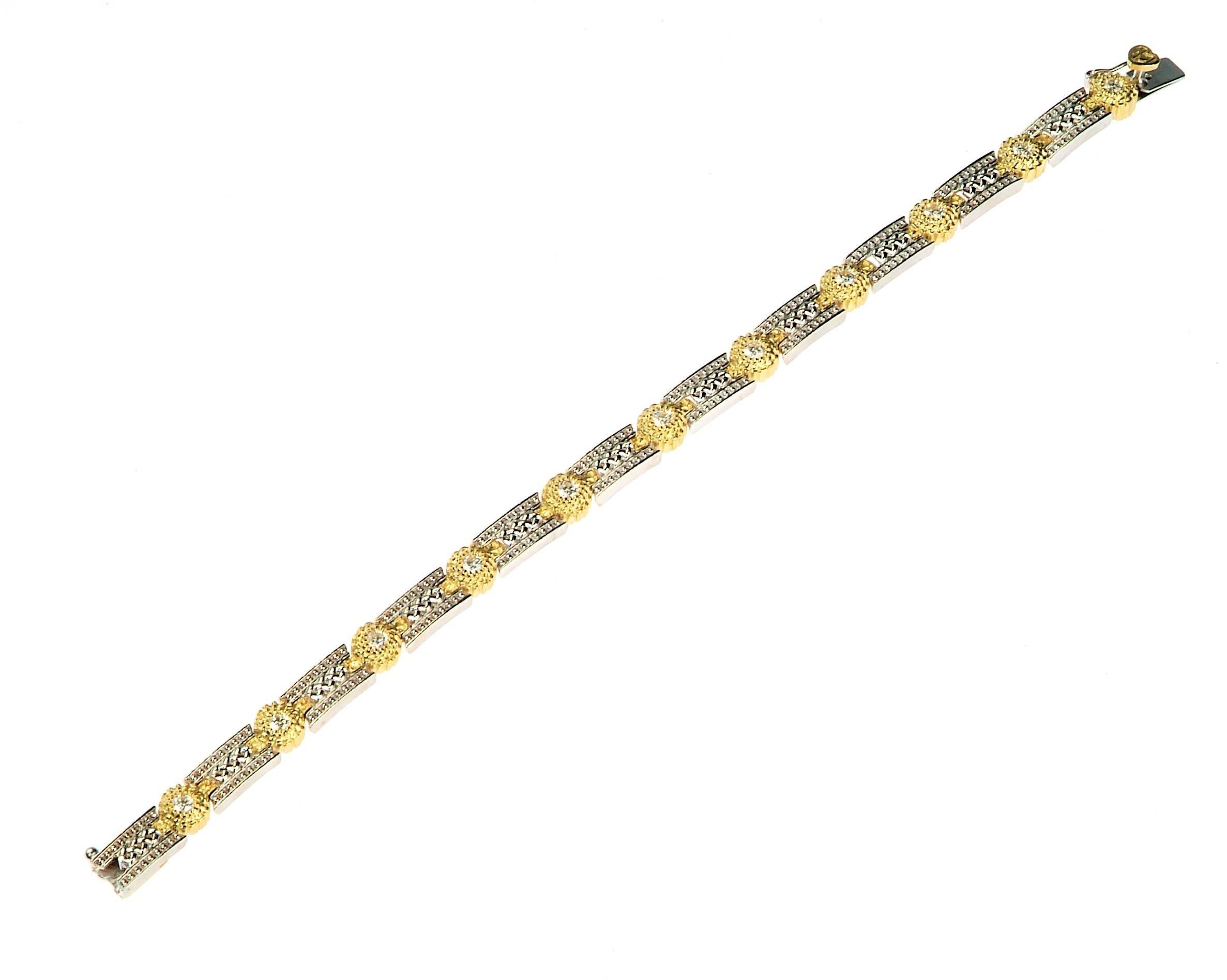 18K White and Yellow Two-Tone Gold Tennis Bracelet with Diamonds by Stambolian

1.10 carat G Color, VS Clarity Diamonds

Push button clasp with safety

7 inches in length
0.3 inch wide

Signed Stambolian and has the Trademark 
