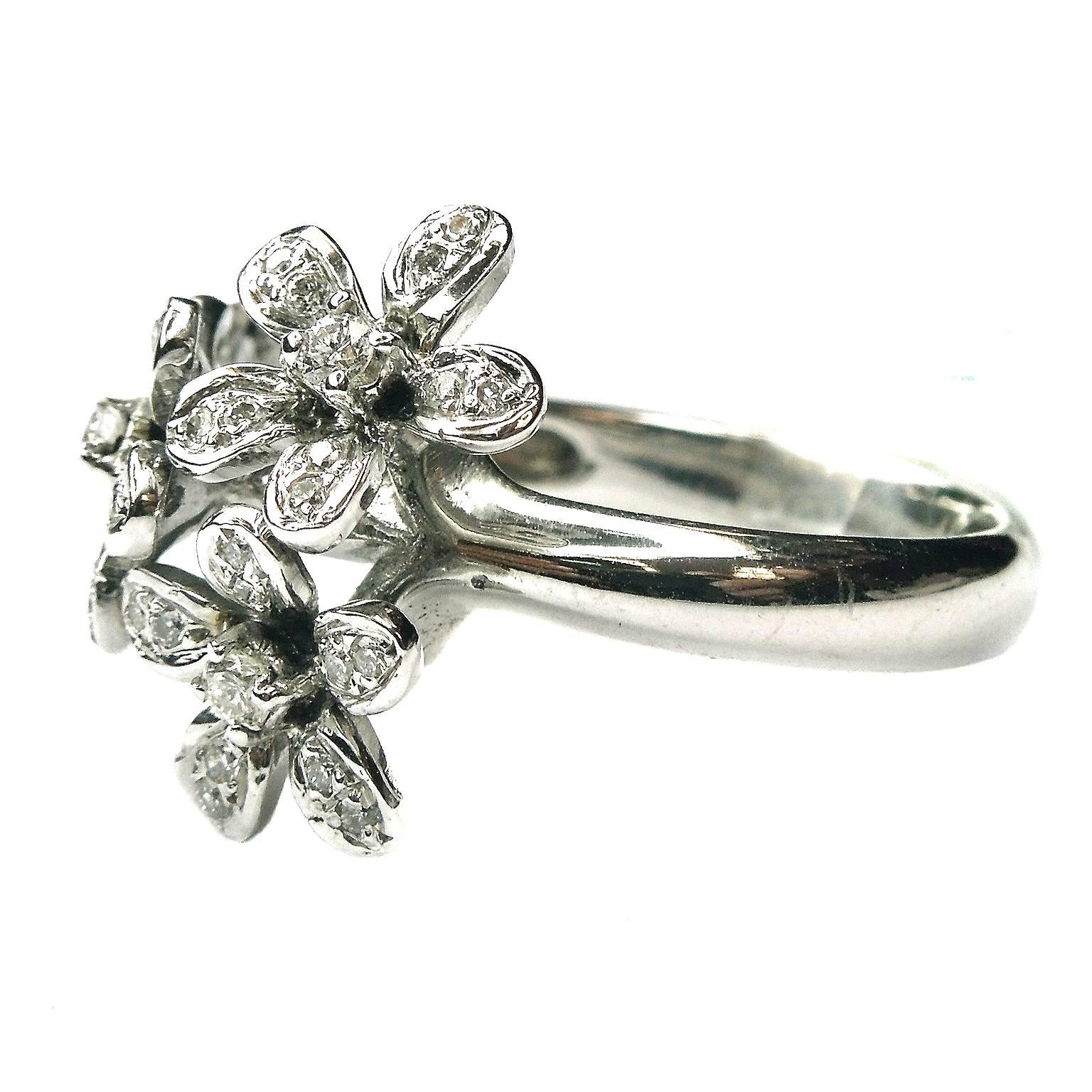 18K White Gold Floral Ring with Diamonds

0.35ct. G Color, VS Clarity Diamonds

4 Flowers make up face of the ring

6.69grams 18k gold

Currently size 5. Can be size up or down.

Face of ring 1 inch wide
0.10 inch band width

Made in Turkey

Estate