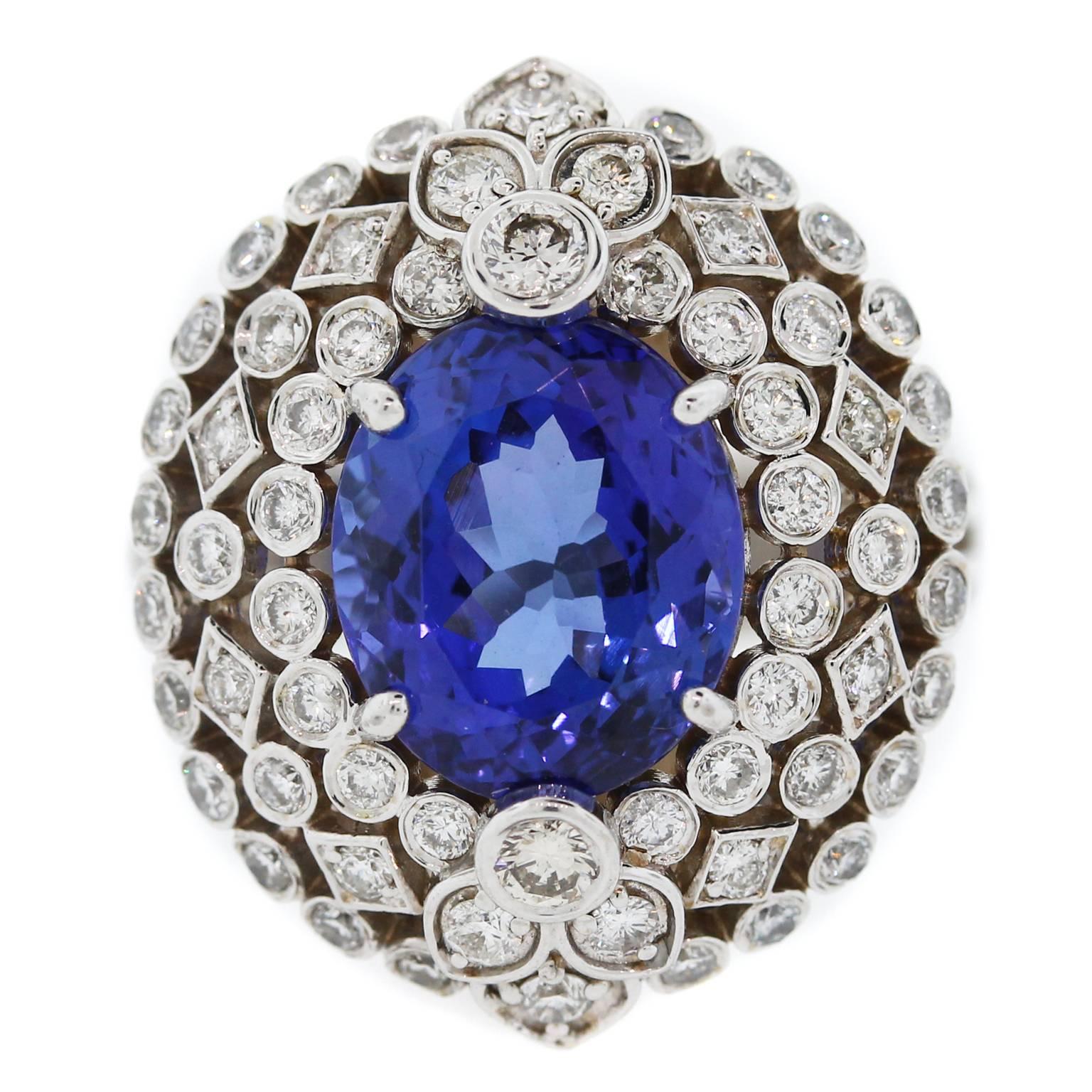 18K White Gold Ring with Tanzanite Center and Diamonds

Center Tanzanite: 11mm x 9mm, 5.57 ct. Beautiful color.

1.09 ct. G Color, VS Clarity Diamonds surround entire face of ring.

Open work design.

Currently size 6.5. Can be sized. 

ONE OF A KIND