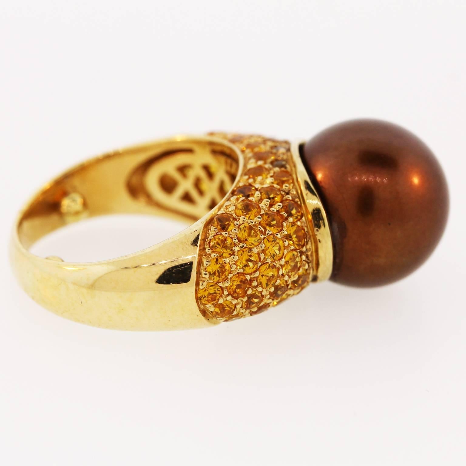 18K Yellow Gold Ring with Brown Pearl center and Yellow Sapphires

(70) Yellow Sapphires 4.00ct. apprx.

One of a kind piece

10.8grams