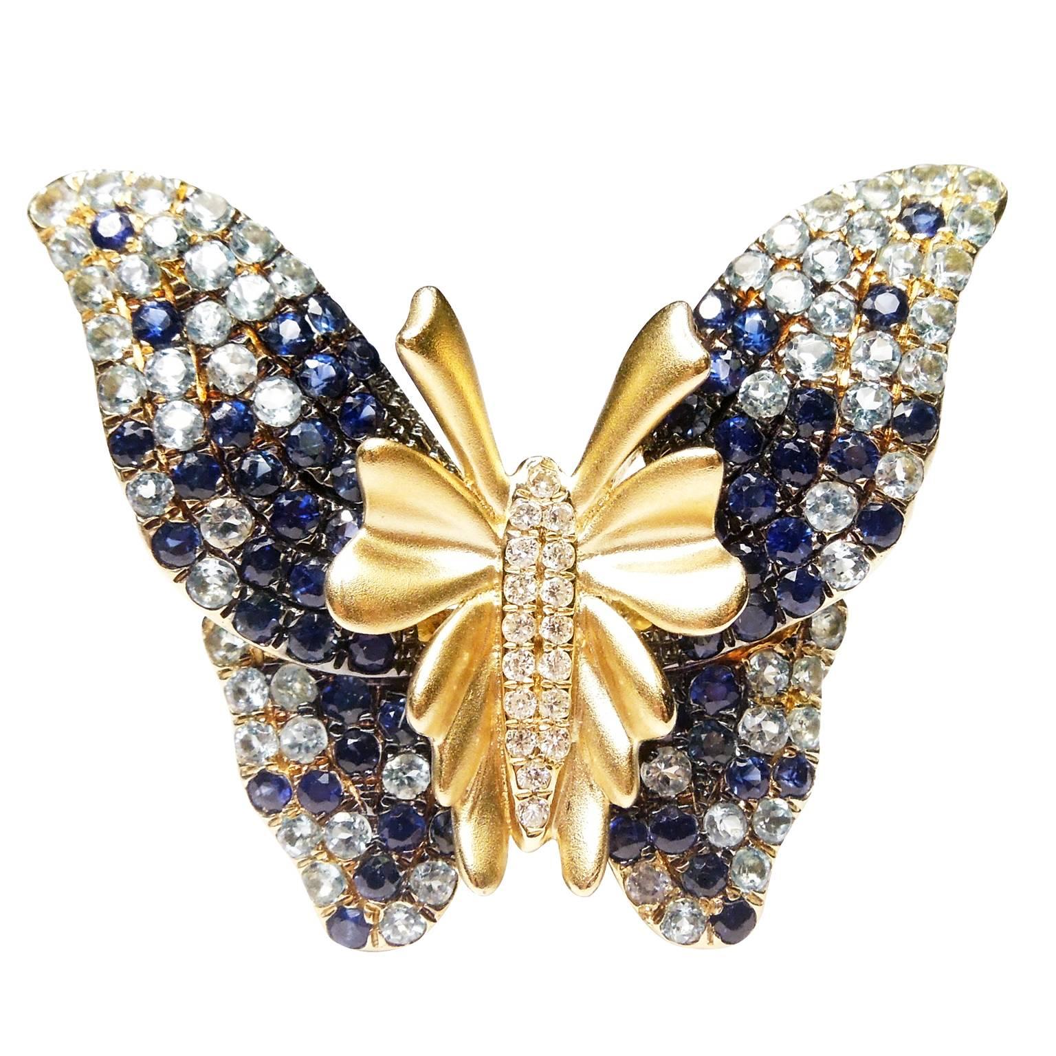 14K Yellow Gold Ring with Shaded Blue Sapphires and Diamonds

0.15ct. Diamonds throughout face

Diamonds are shaded from from dark blue to light.

Butterfly is 1.4 inch width x 1.2 inch length

8.6g 14K Gold

Currently size 6.5. Can be sized.

Estate