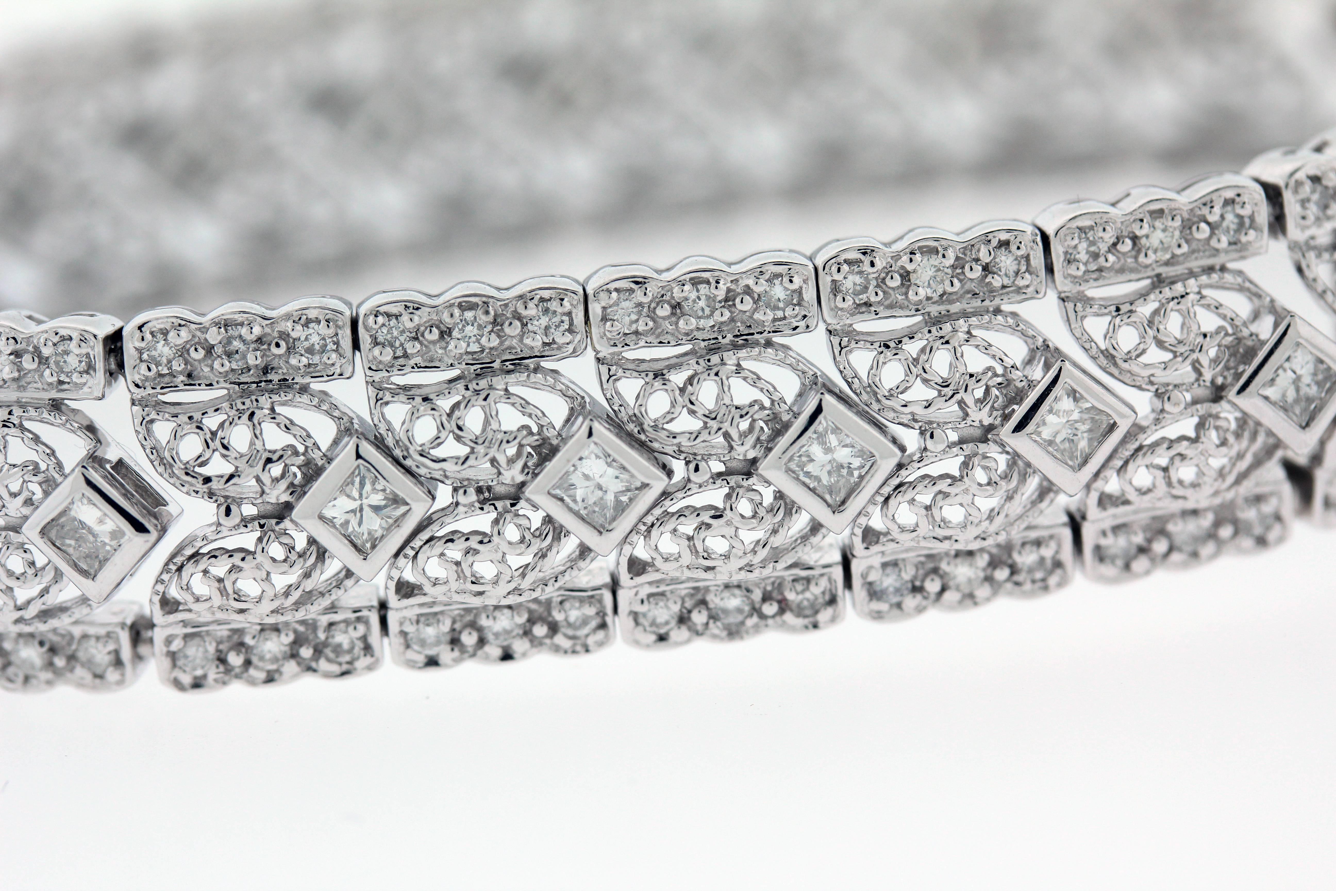 14K White Gold Open Work Bracelet with Round and Princess Cut Diamonds

3.70ct. apprx. Round and Princess Cut Diamonds make up the entire bracelet.

Gorgeous design is seen throughout piece, with open work sections.

Bracelet is 7 inches in length x