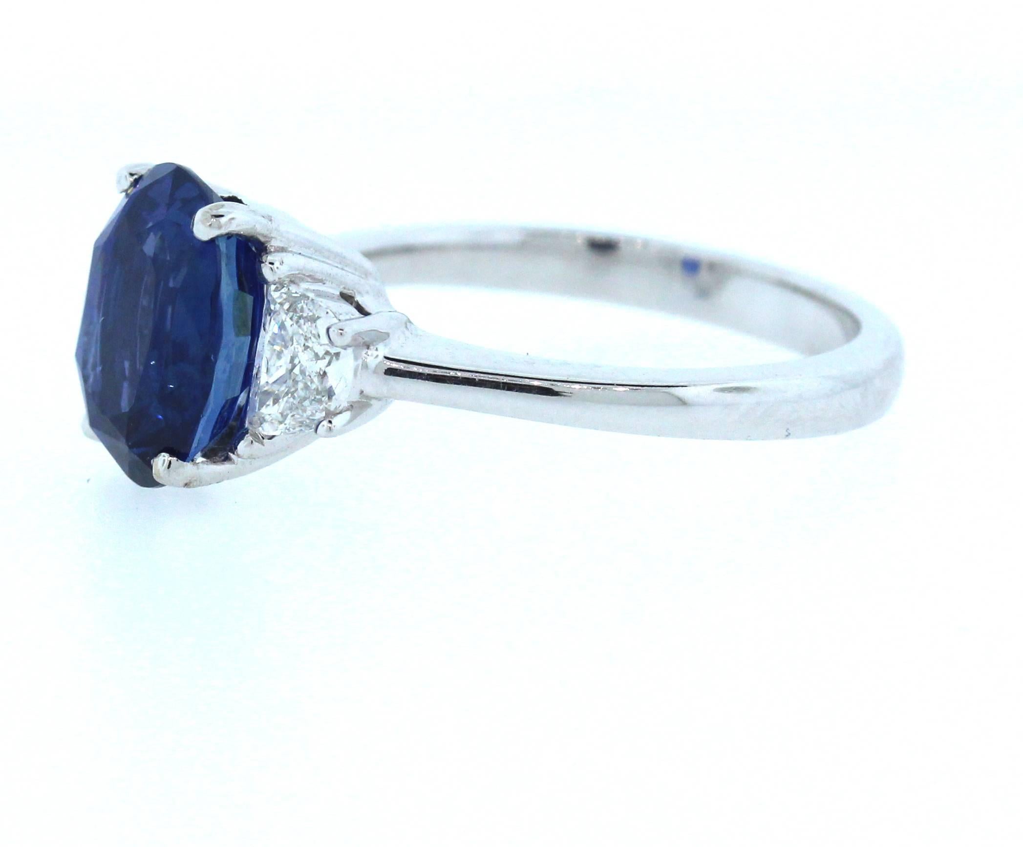 AGL Certified Ceylon Blue Sapphire with Two Trapezoid Diamonds 

Ring is done in 18K White Gold

Blue Sapphire is 4.00 carat. Oval shape. From Ceylon (Sri Lanka). 
NO Heat all natural color.

Certification states: "non-heated sapphires are