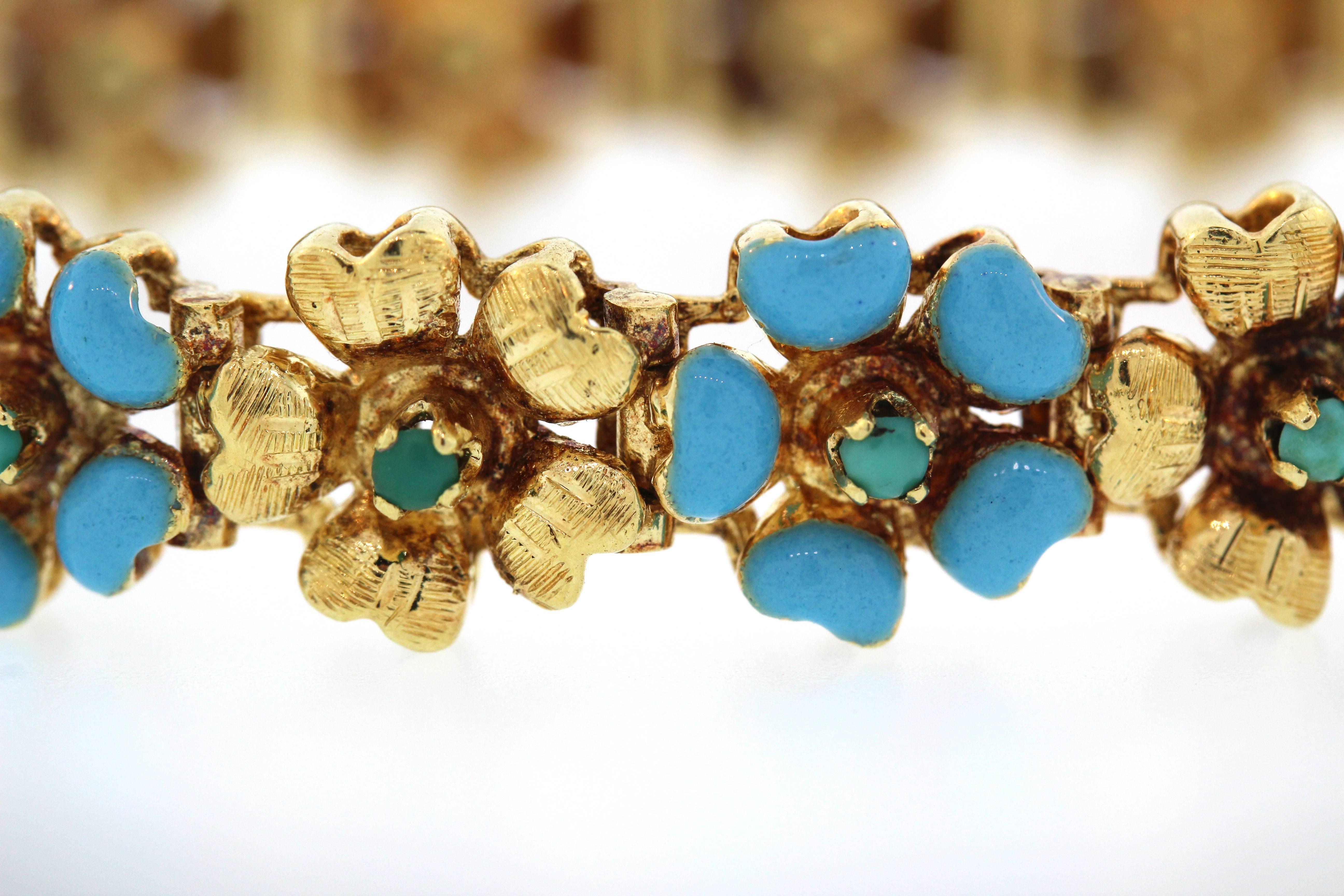 18K Yellow Gold Bracelet with Turquoise and Enamel

Flower leaves are done in Blue Enamel. Flower centers are turquoise.

Bracelet is made in Italy by 