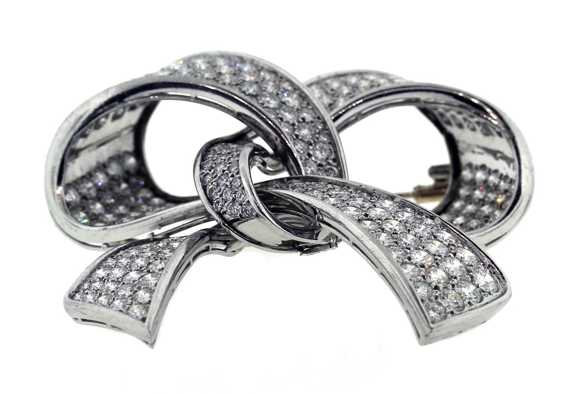 18K White Gold and Platinum Ladies Ribon Brooche Pin with Diamonds

Apprx. 25 carats of G Color, VS Clarity Diamonds cover this entire Ribbon Brooche Pin

Pin is 2.5 inches in length and 2.4 inches wide

Estate