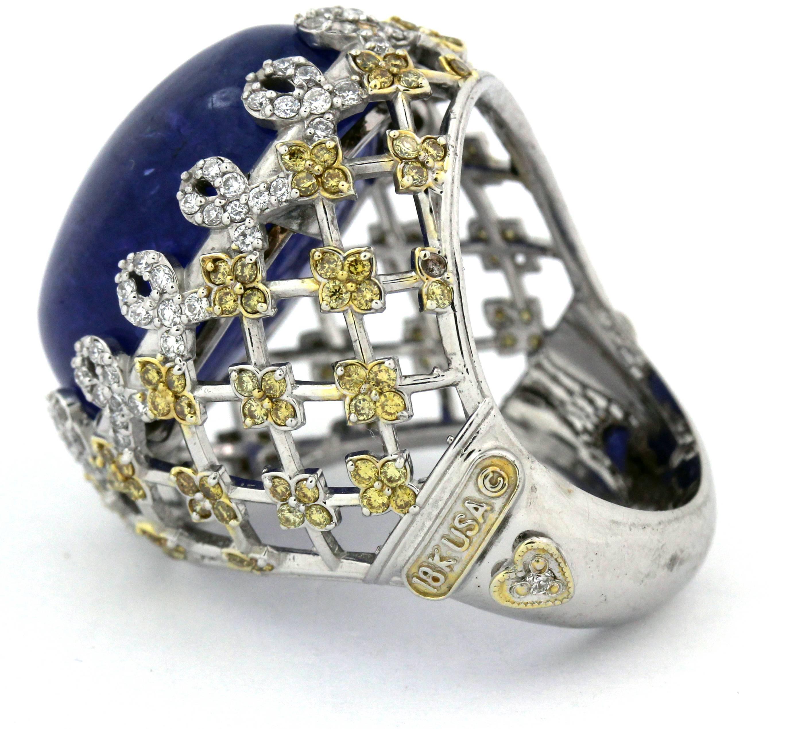 Estate 18K White Gold Ring with Cabochon Tanzanite center and Yellow and White Diamonds by Stambolian

Center Tanzanite, cabochon-cut, 33.70ct. Beautiful, clean stone.

Basket-type ring has yellow and white diamonds on sides.
0.60ct. apprx. G Color,