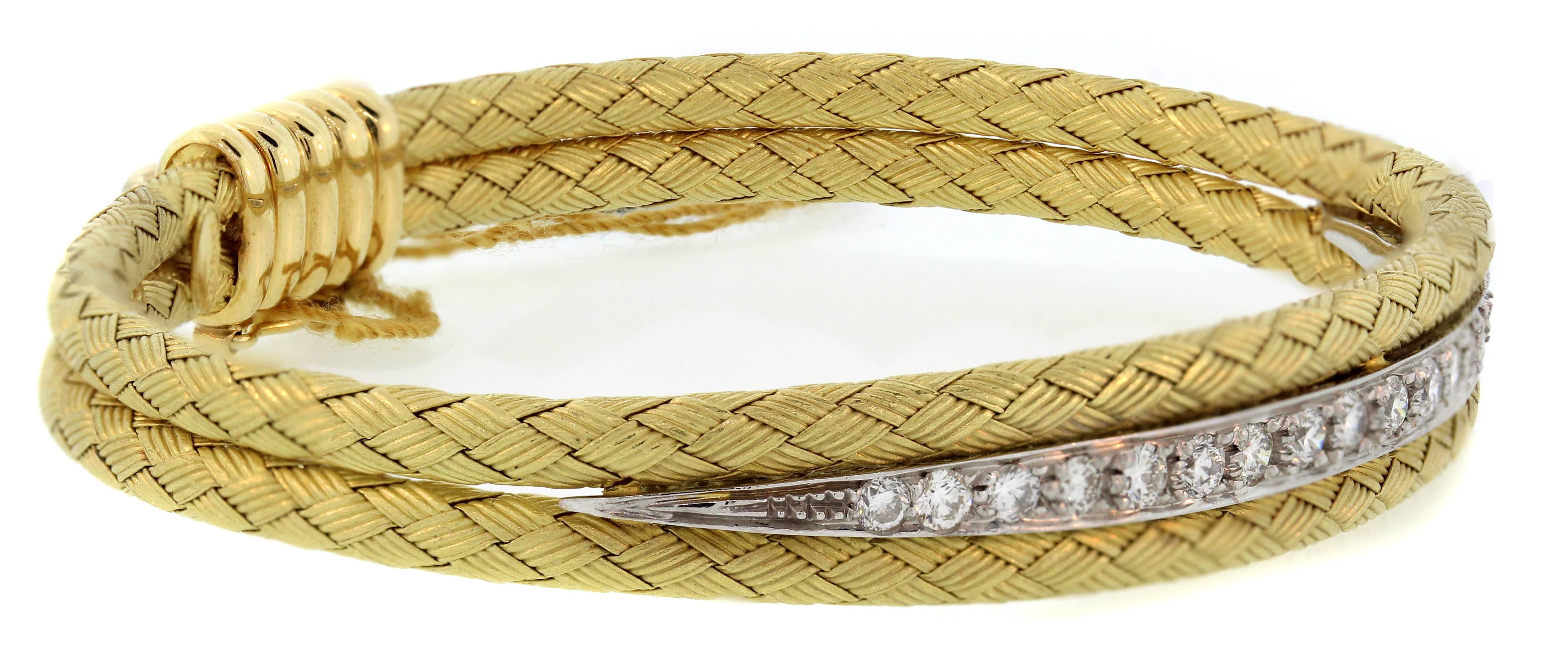 18K Yellow and White Gold Bracelet with Diamonds 

0.90ct. Diamonds cover mid section of bracelet surrounded by gorgeous textured design work.

Bracelet is 0.35 inch wide and 7 inches in length.

Push open clasp along with safety used to lock and