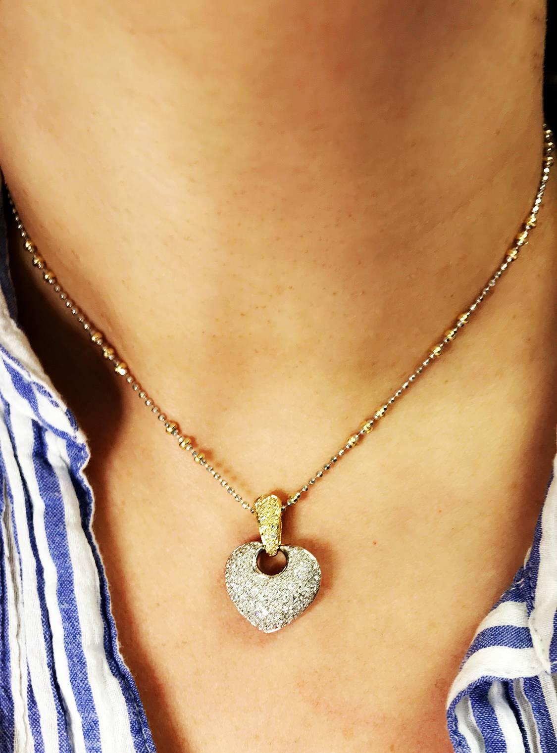18K Yellow and White Gold Heart Pendant with Two-Tone Chain

Heart pendant has diamonds covering entirely.

Heart has 1.43ct. diamonds set.

Chain is done in yellow and white gold. 16 inches in length.

Heart pendant is 1 inch in length.