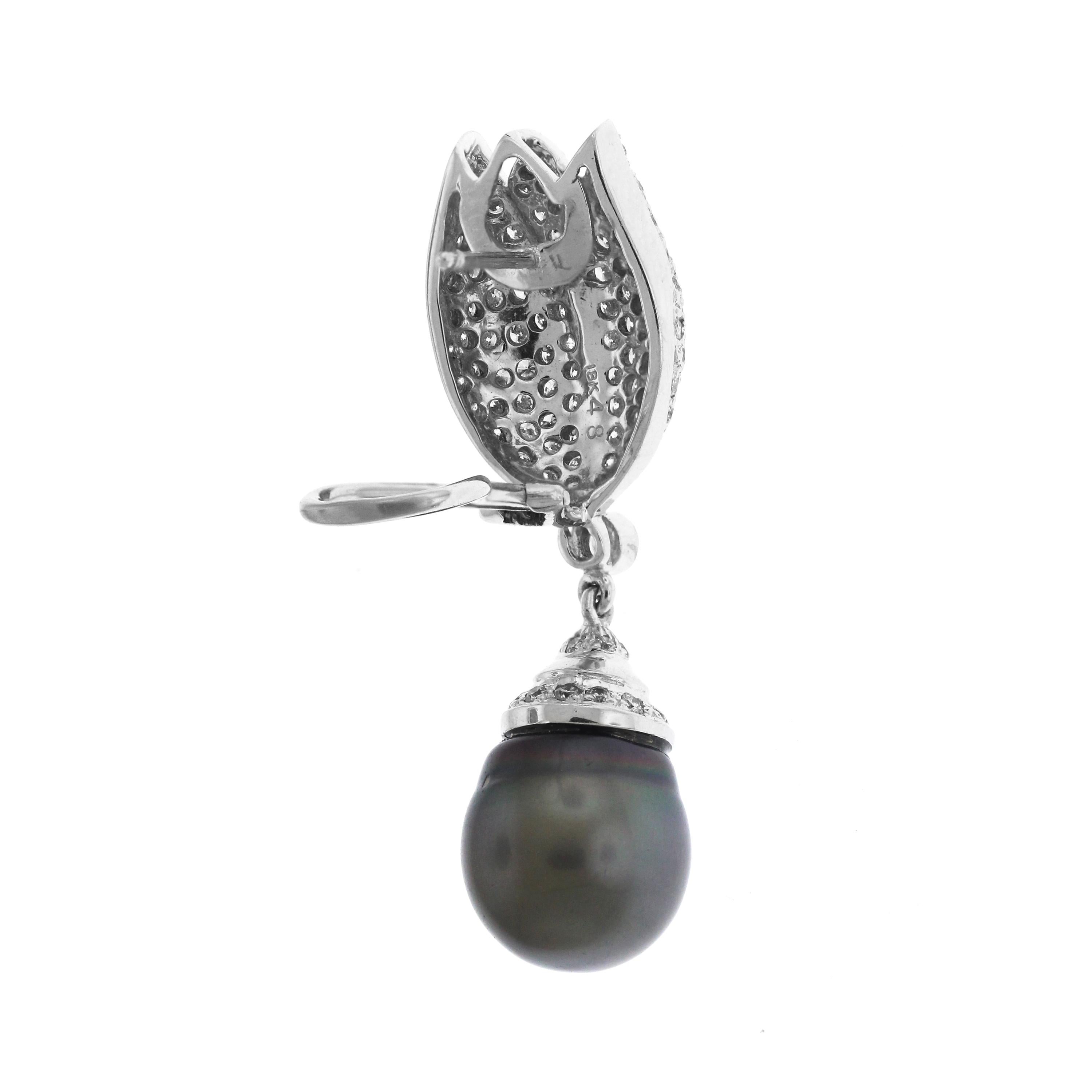 18K White Gold and Diamond Drop Earrings with TahitianBlack Pearls

13mm Tahitian pearl drops

1.50 carat H color, SI clarity diamonds 

Post-omega backs

Earrings are 1.9 inches length x 0.6 inch width