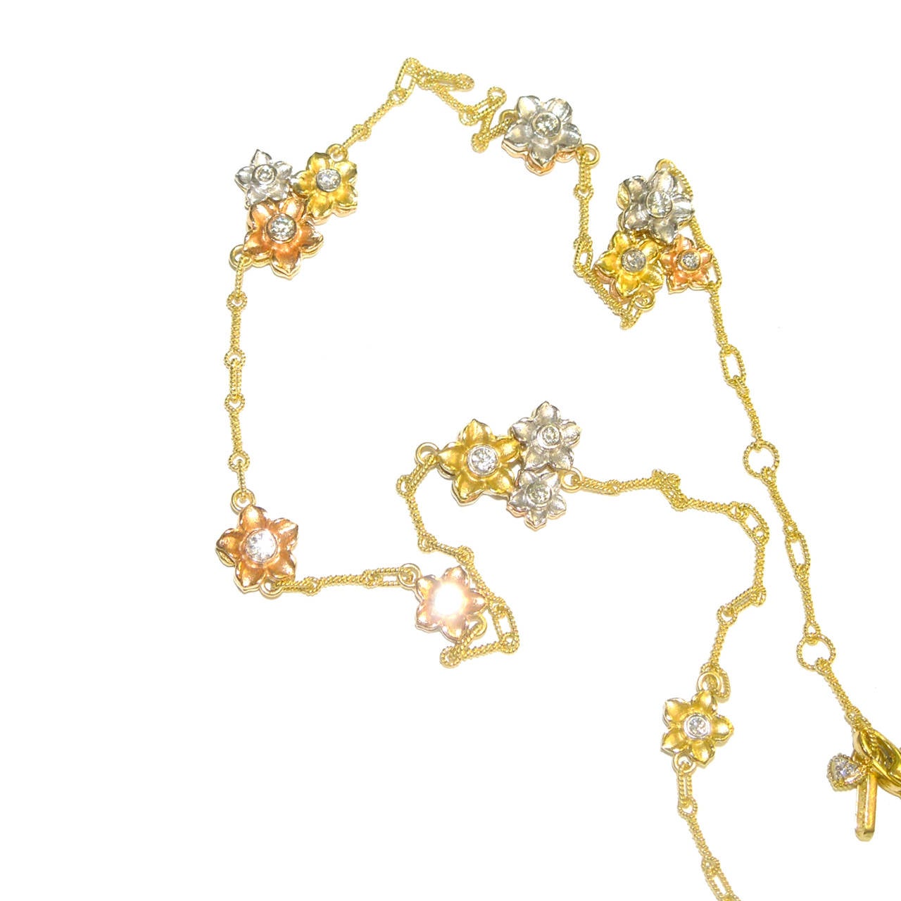 18K Gold Necklace with double sided Diamond bezels

Flower bezels are done in Yellow, White & Pink Gold and diamonds are double sided

Chain used is done with 18K Gold Hand Twisted wires

1.77 ct.'s of G Color, VS Quality Diamonds

Has three