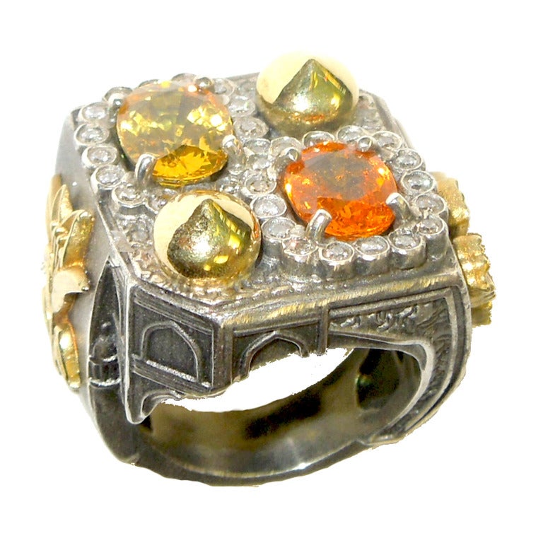 Aged Silver & 18K Gold Ring with Mandarin Garnet, Yellow Sapphire and Diamonds

Details seen on piece are that of the Taj Mahal

Mandarin Garnet- 1.91 ct.
Yellow Sapphire, 2.27 ct.
Diamonds- 0.48 ct.

Available in sizes 5-12. Currently 6.5.

Signed