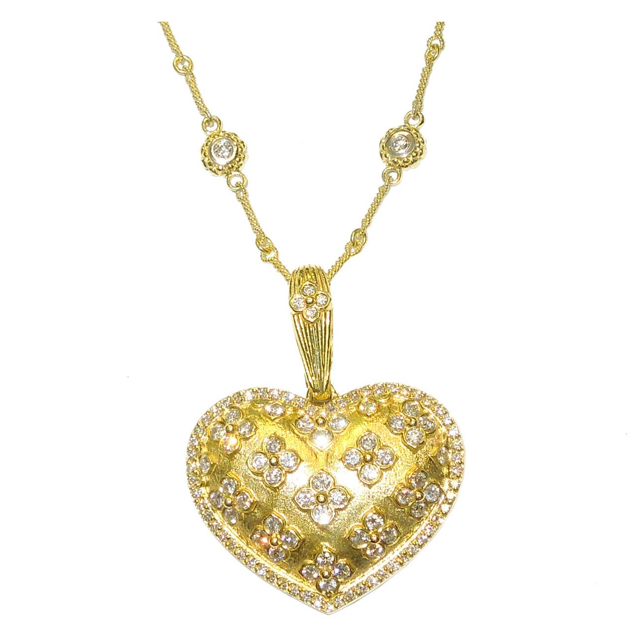 18K Gold Heart Enhancer Pendant with Diamonds

2.55 ct.'s of G Color VS Quality Diamonds set on center and around the piece and bell

From bell to bottom is 2 inches in length

1.5 inches width 

From our 