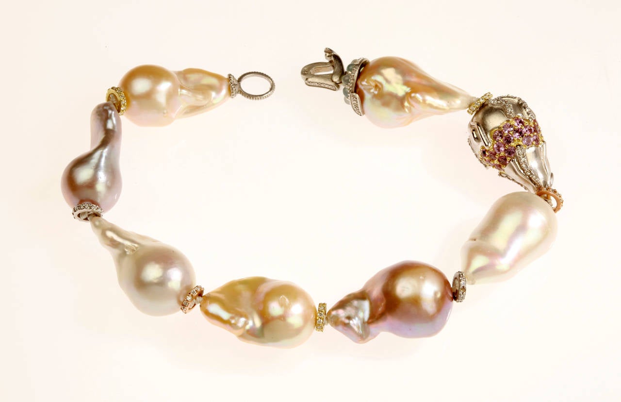 Baroque Pearl Bracelet with 18K Gold Rondel and Multi-Color sapphires & Diamonds

0.92 ct.'s of G Color, VS Quality White Diamonds

1.44 ct.'s of Mult-Color sapphires

In between each pearl is a diamond loop showing the separation between each