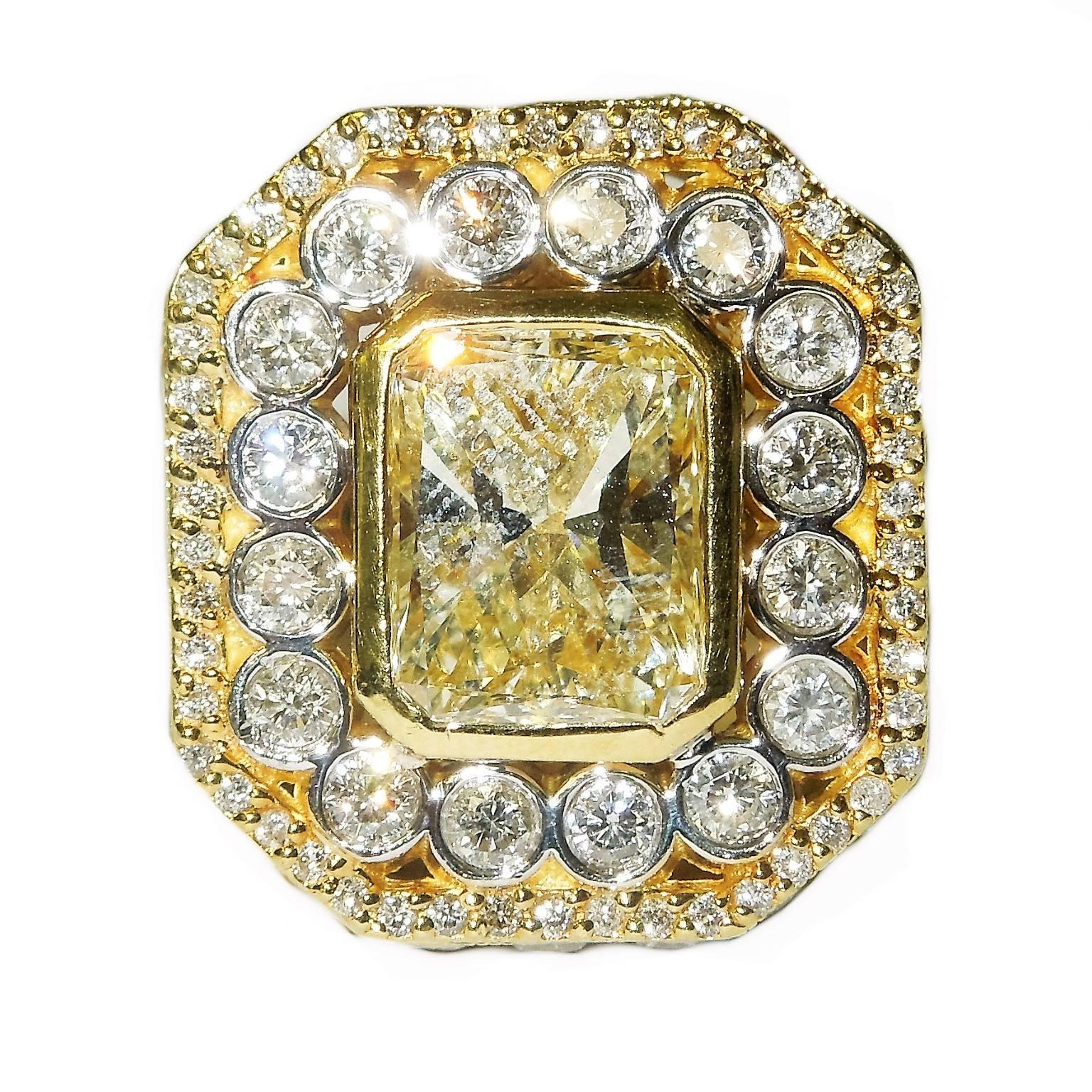 18K Gold Ring with 5.01 ct. Natural Light Yellow Radiant Diamond Fancy Yellow

5.01 ct Radiant shape diamond VS2 clarity. 
Dimensions of stone: 11.33mm X 8.96mm X 5.91mm

Rest of the the ring has 3.53 ct. G Color, VS Quality Diamonds

Total