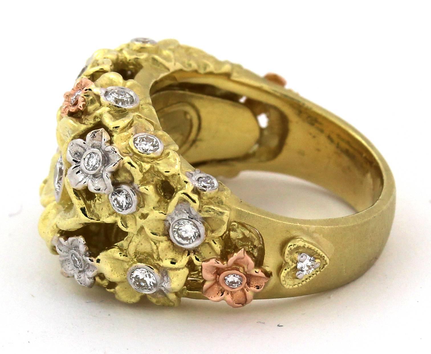 18K Tri-Color Gold Flower Ring with Diamonds by Stambolian

0.60ct. apprx. G Color, VS Clarity Diamonds 

Currently size 6.5. Sizable

Ring face is 0.5 inch wide. Band is 0.3 inch wide

Has the Stambolian 