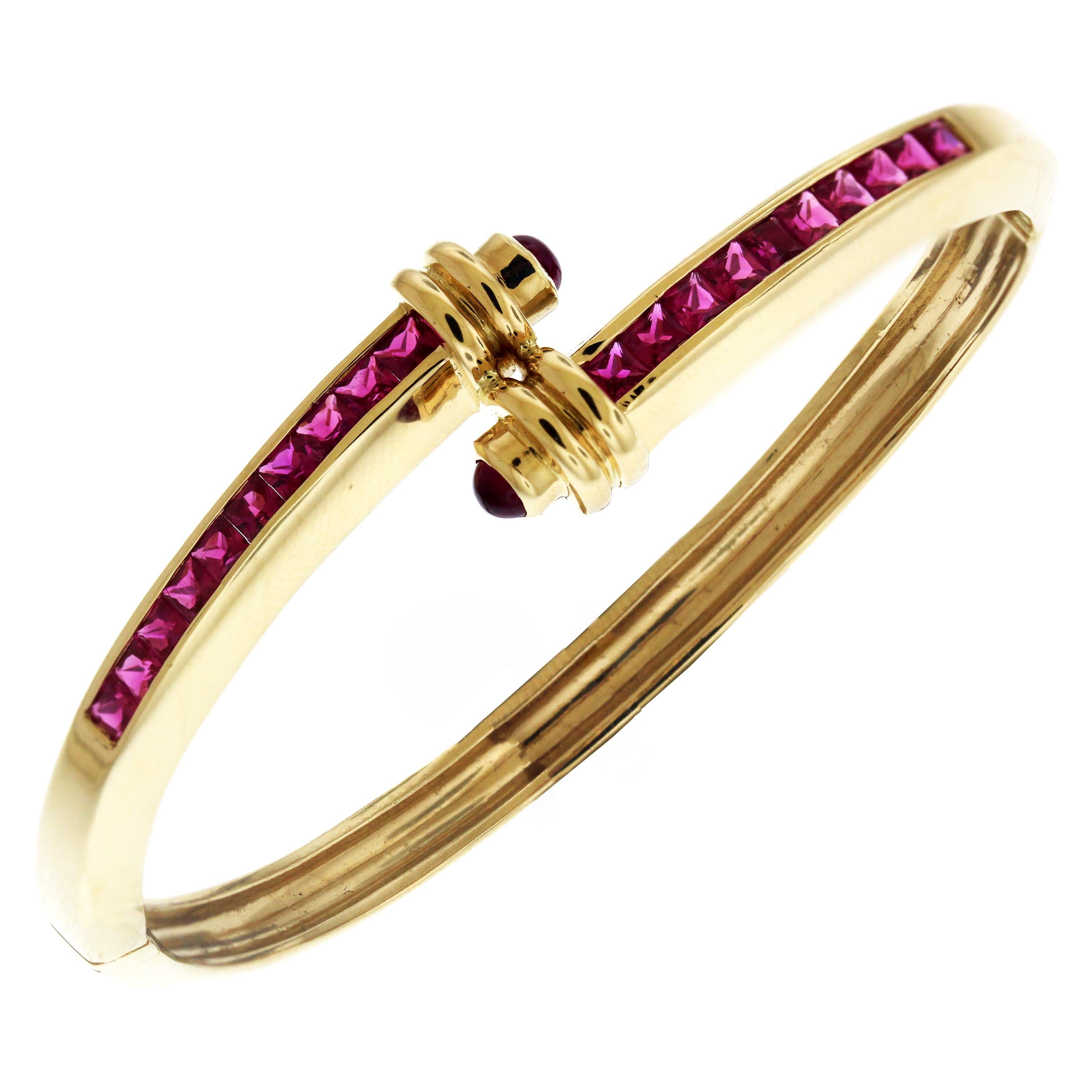 18K Yellow Gold Crossover Bracelet and Ring set with Princess Cut Rubies

Bracelet has 2.50 carat Rubies

Bracelet measures 7 inches in length, 0.25 inch width.

Yellow Gold Ruby and Cabochon Crossover Ring:

18K Yellow Gold Ring with Princess Cut