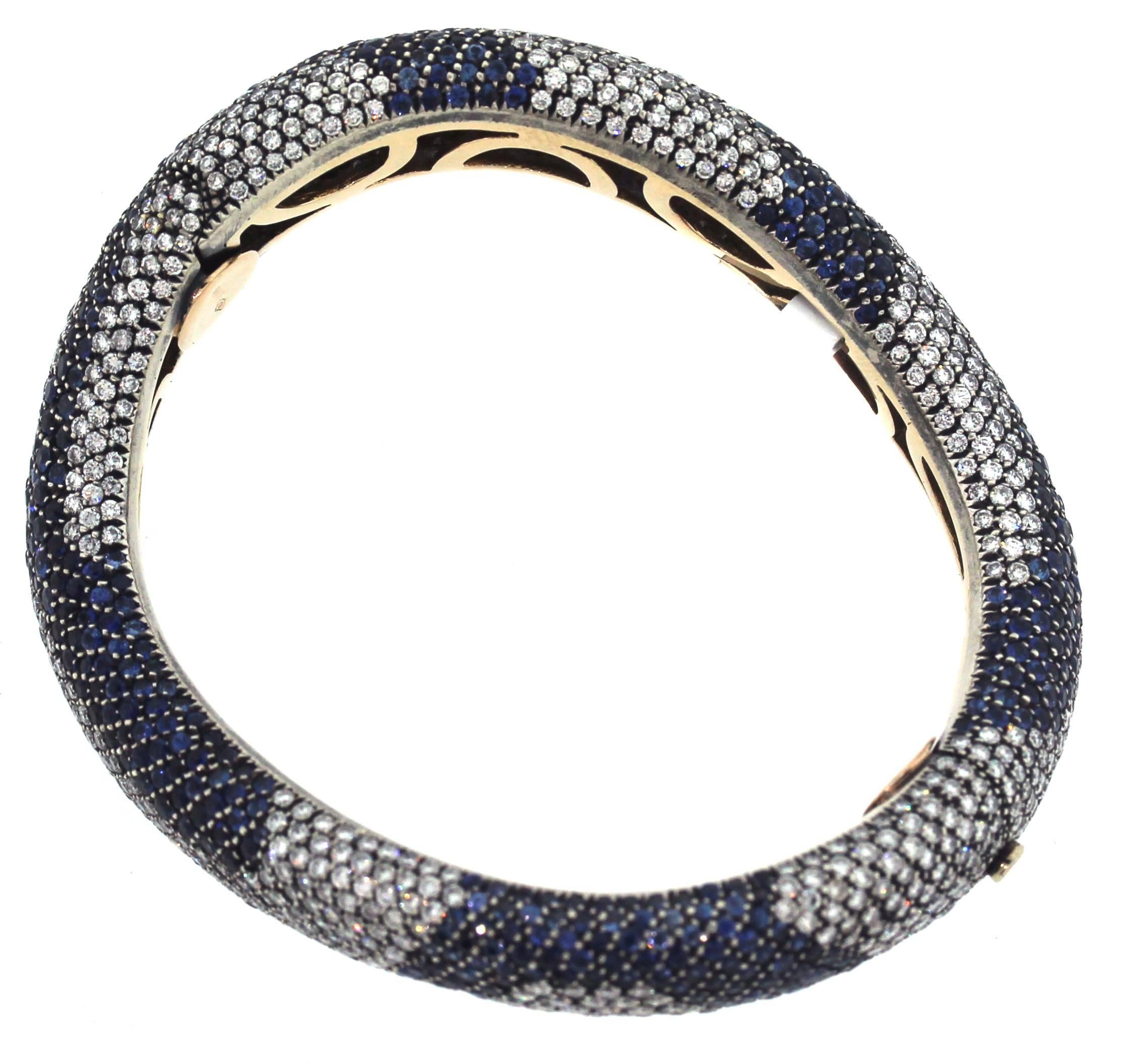 Cantamessa 18K Gold Shaded Blue Sapphire and Diamonds Curved Bangle Bracelet

9 carats apprx. Blue Sapphires 

8.50 carat G color, VS clarity diamonds 

Bracelet is a size 7.
0.5 inch width.

Cantamessa is an American Designer from New York
