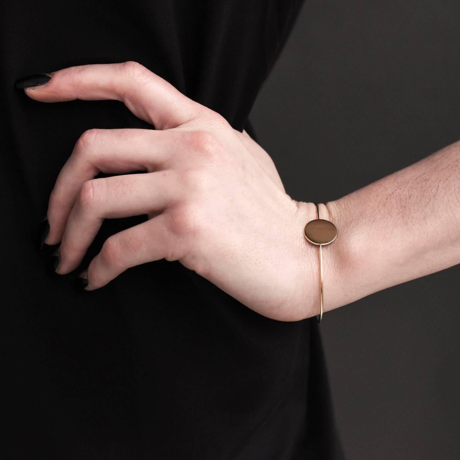 A cuff bangle which sits snugly against the wrist and the highly polished finish of the circle flashes gold light with movement. Very comfortable to wear, this bangle may stay on your wrist all the time and not just for special occasions! 