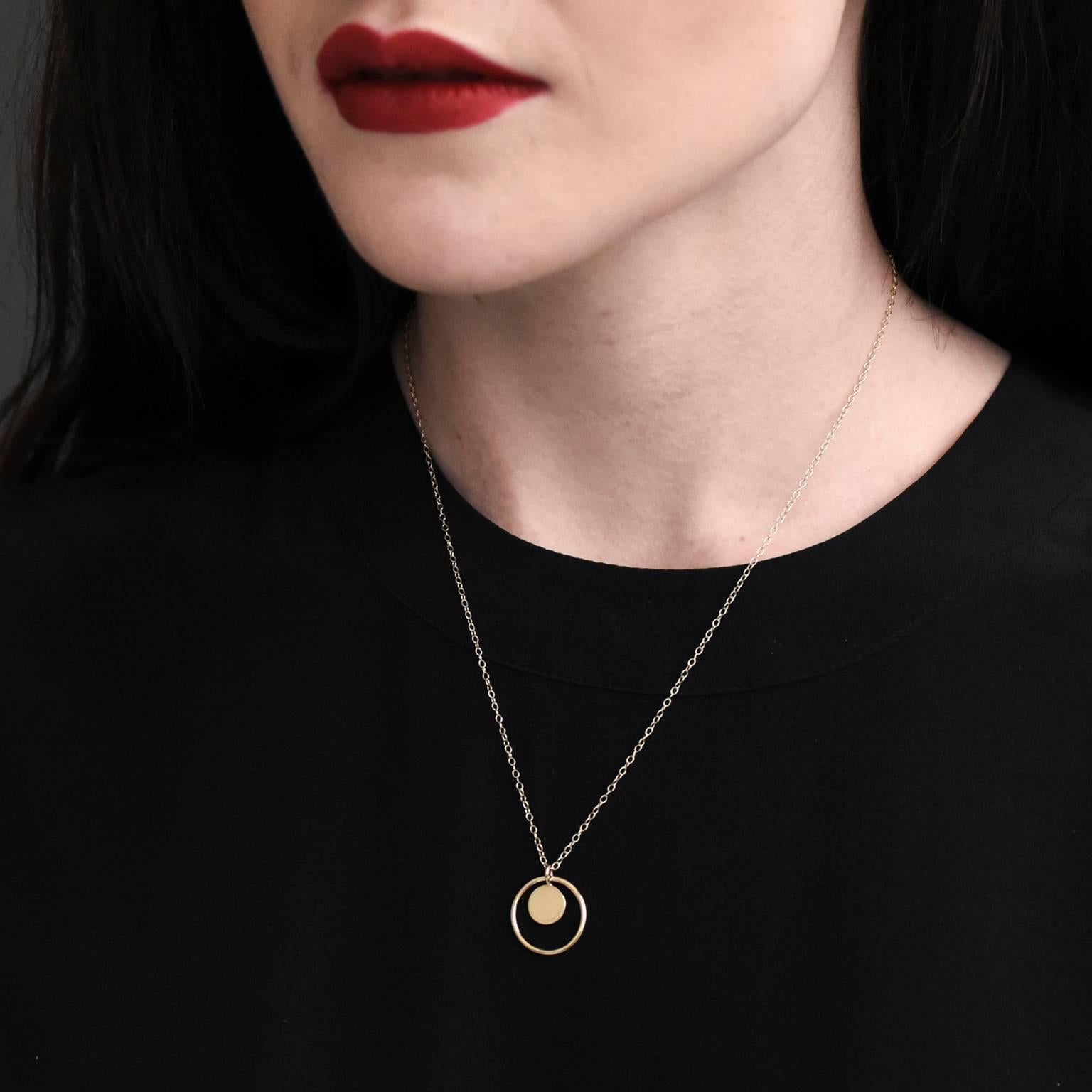 A pendant of two parts, the golden circular outline spins freely in the bail of the gold disc, perfect for those girls who like to fiddle with their jewellery! The pendant overall isn't too large, and can be easily worn with other gold necklaces for