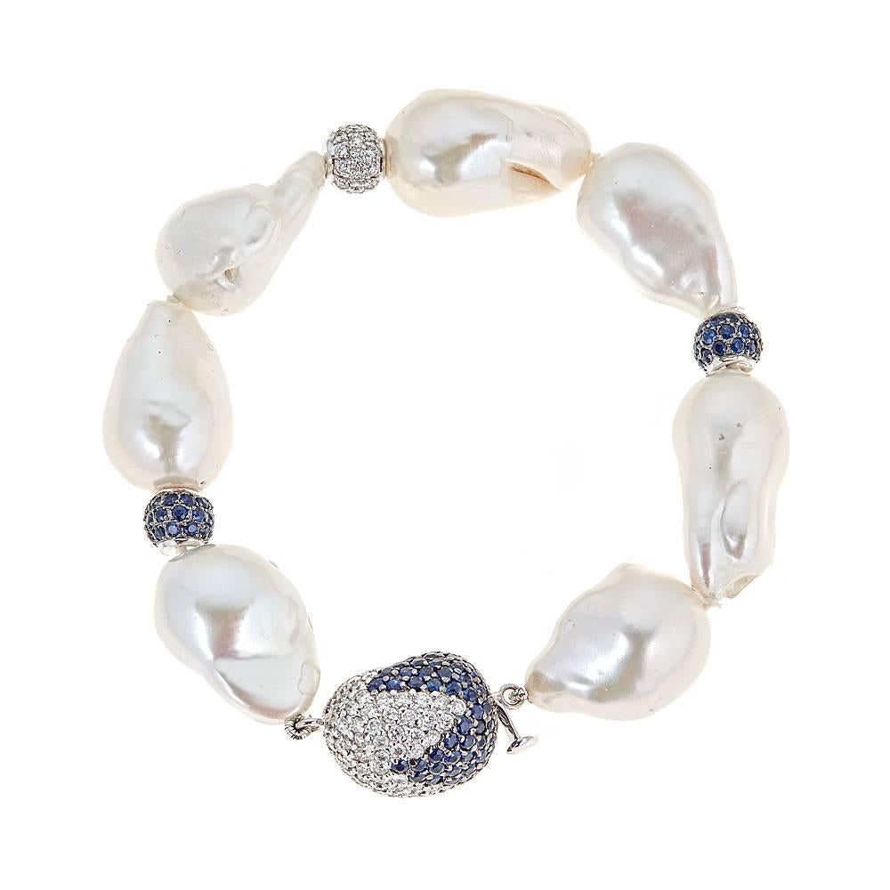 Featuring magnificent Baroque White South Sea Pearls, this bracelet revitalizes a classic with 5.37 carats of Blue Sapphires and 2.50 carats of round diamonds set in 18K White Gold. 

Features: Color variations available upon request; Slide in