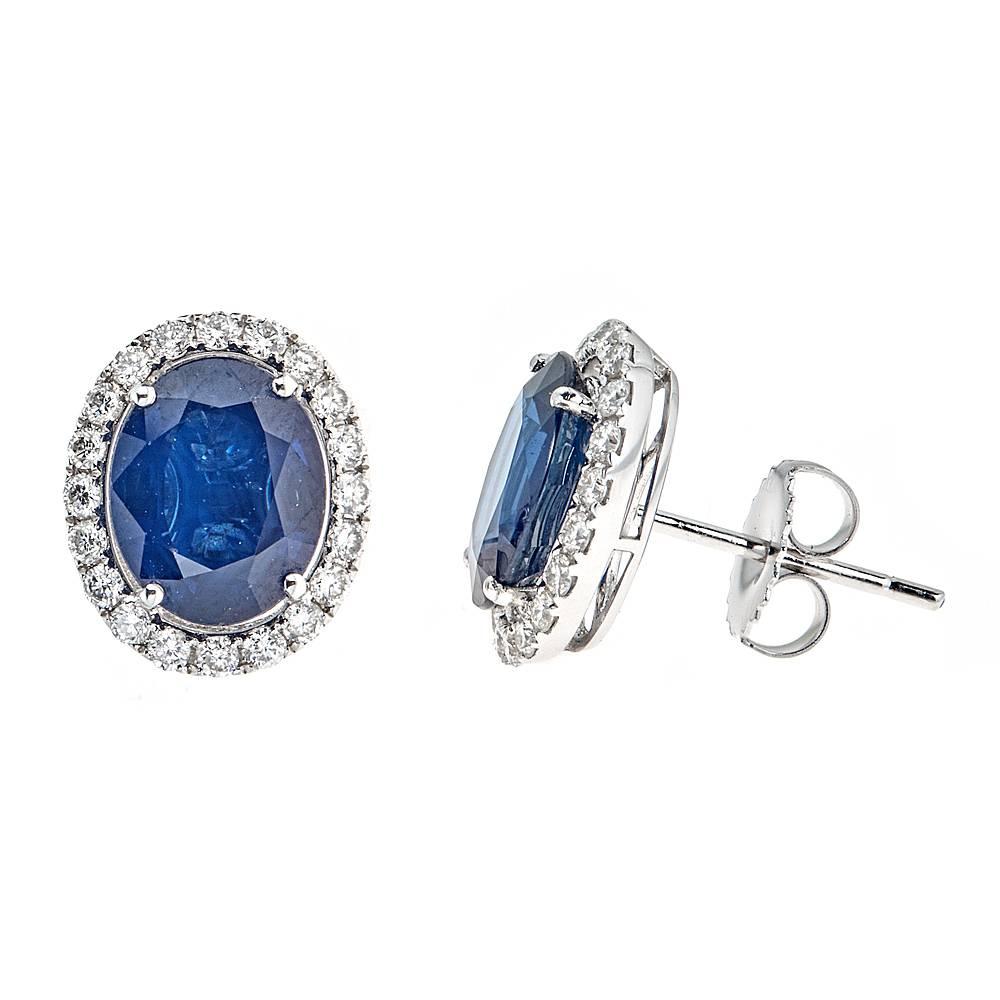 These 18K white gold earrings feature 6.00 carats of stunning oval blue sapphires.  Surrounding the richly colored sapphires are 0.65 carats of round white diamonds for an elegant, timeless finish. 

Features: Post Back 
Total Weight: 3.94g