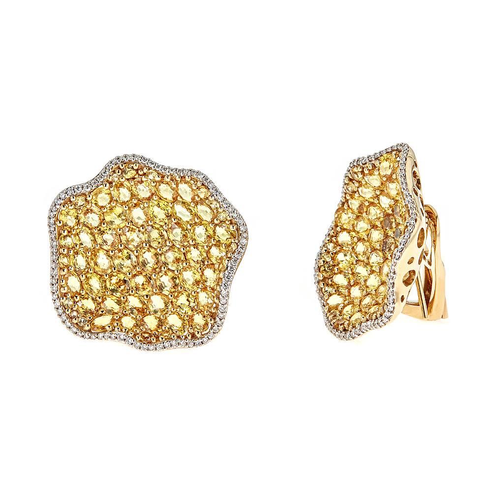 Vibrant 18K Yellow and White gold earrings. 19.46 carats of round and oval Yellow Sapphires are beautifully framed by 0.69 carats of round white Diamonds in these effortless, ready-to-wear pieces. 

Features: Bendable Post Clip Back
Total Weight: