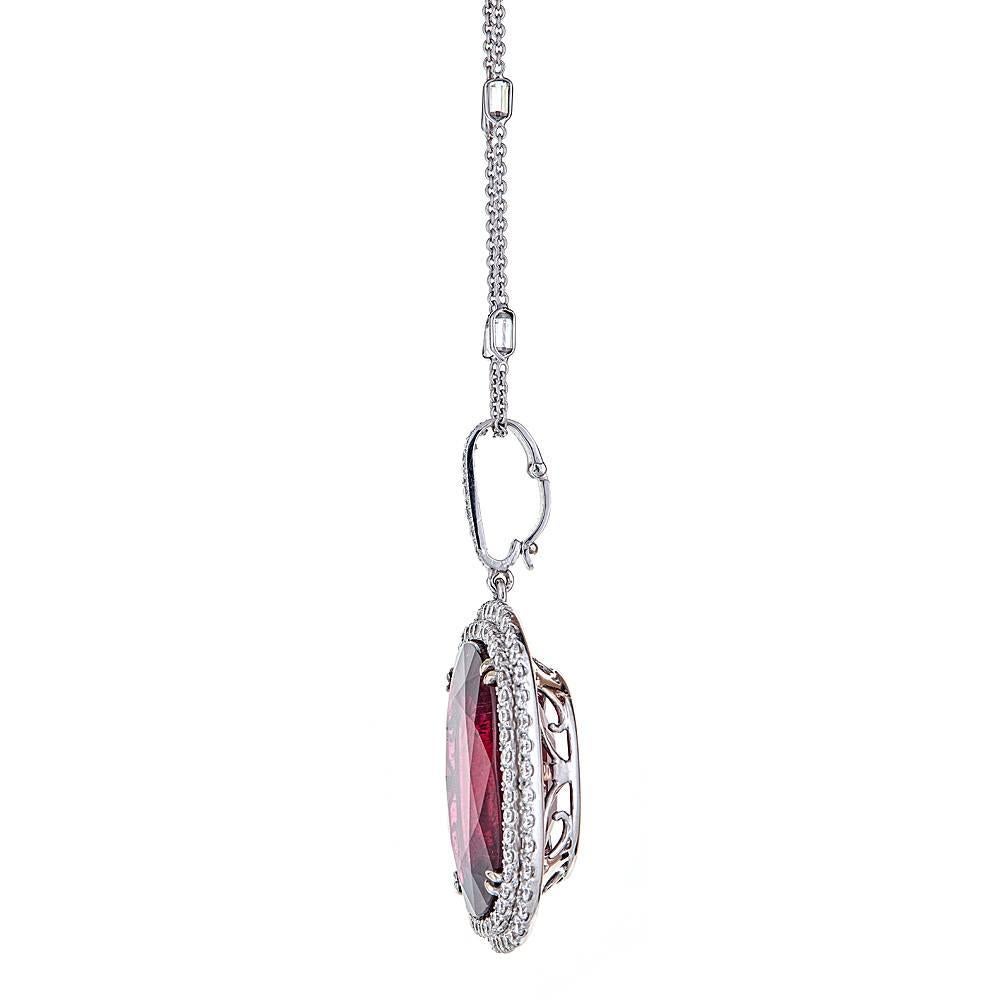 An exquisite rubelite and diamond pendant with accompanying chain. 

Two rows of round Diamonds, 7.08 carats in total, frame an extraordinary, lush and vibrant 52.23 carat cushion Rubelite. Set in 18K White Gold, this pendant is featured with a
