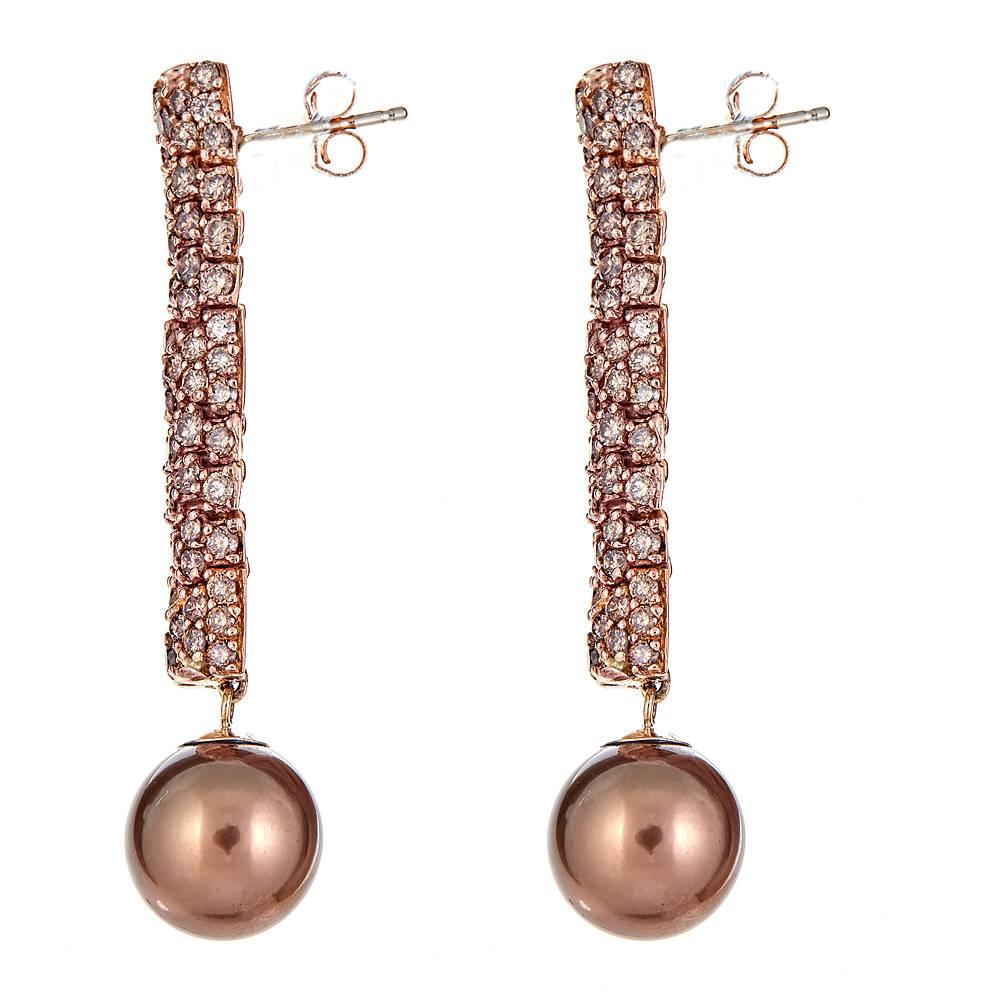 A pair of decadent 18K Rose Gold drop earrings. With an ornate strand of round, brown pave Diamonds, a total carat weight of 3.95, these flexible, sleek drop earrings are completed with two gorgeous 10.9 x 10.8 mm bronze, South Sea