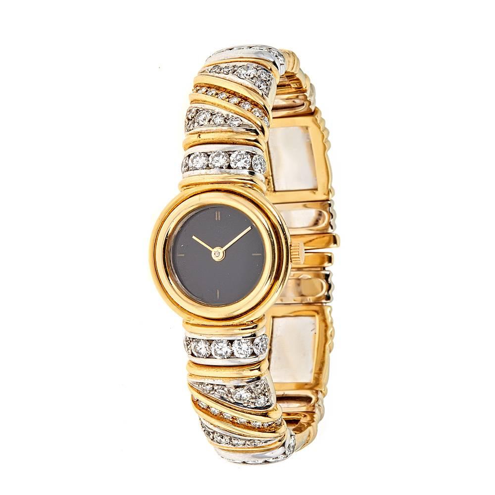 A modern, sleekly designed bracelet watch with 3.66 carats of round, white Diamonds. 
With weaving patterns of 18K Yellow Gold and round white diamonds set in 18K White Gold, this thin, contemporary watch, with striking black watch face, is perfect