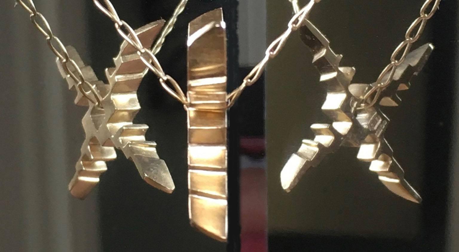 Detailed and angular, this solid gold pendant boasts 4 sides of architectural beauty. Sometimes viewed as a Japanese Shuriken weapon and other times mistaken for a contemporary St Brigid's Cross, the nuance of meaning is half its charm! Free