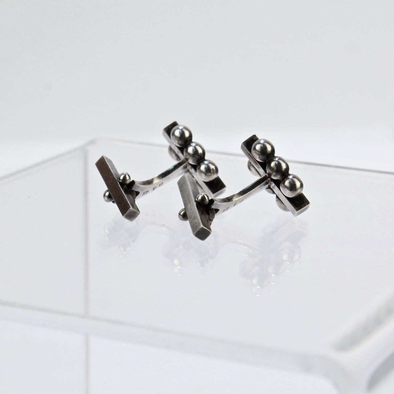 Georg Jensen No. 61B sterling silver cufflinks. 

Designed by Harald Nielsen.

Marked to side Georg Jensen sterling Denmark and 61B.

MEASUREMENTS
Height: ca. 3/4 in. 
Width: ca. 2/3 in.

Items purchased from David Sterner antiques must delight you.