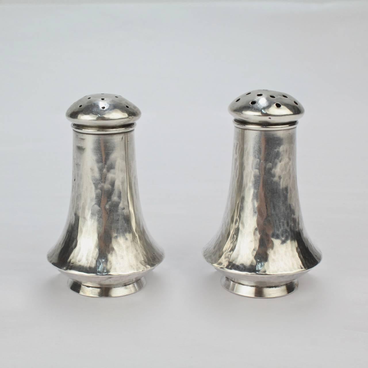 A fine pair of Clemens Friedel sterling silver hand made salt and pepper shakers.

Friedell was an important American Arts and Crafts studio silversmith in Pasadena, California in the 20th Century. Born in New Orleans, Friedell trained in Austria as