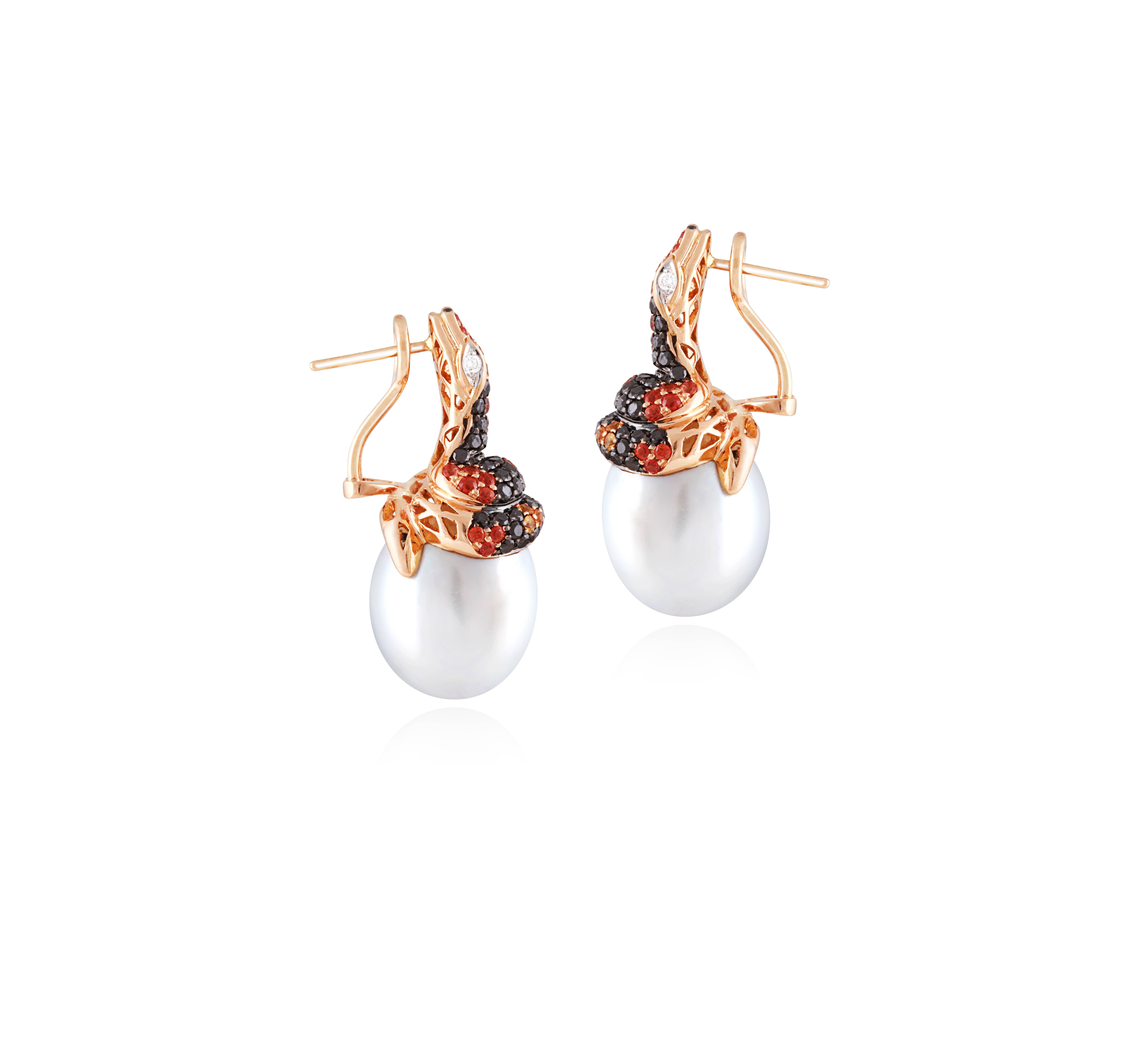 These Elegant Snake Earrings are created with Australian South Sea Pearls measuring 14.5 mm in diameter.  The snakes are adorned by  100 pieces of black diamonds weighing 1.39 Cts, 73 stones with two tones of Orange Sapphires with a weight of 1.06