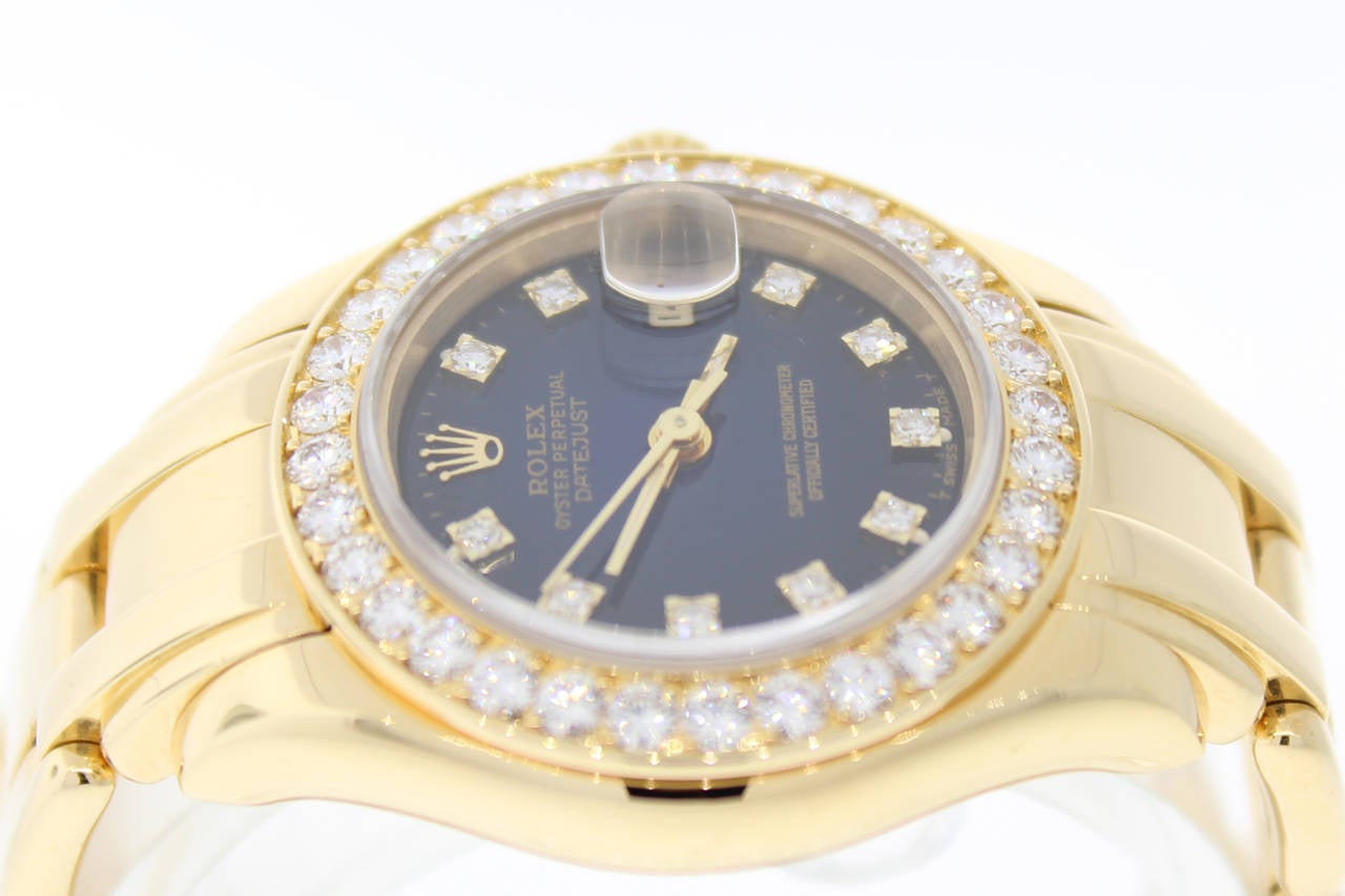 Featured here is a Rolex ladies 18k yellow gold masterpiece original vignette diamond dial/original pave set diamond bezel and Original Factory Sticker. It has a hidden deployment clasp.