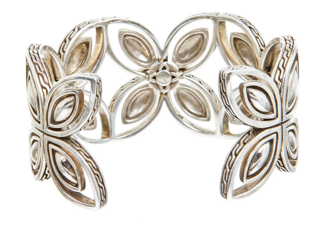 

This glamorous and unique ring is part of John Hardy's the Kawung Collection. John Hardy is known as one of the best luxury designers of handmade jewelry. This cuff stands out with its highly patterned rich texture and floral patterns which is