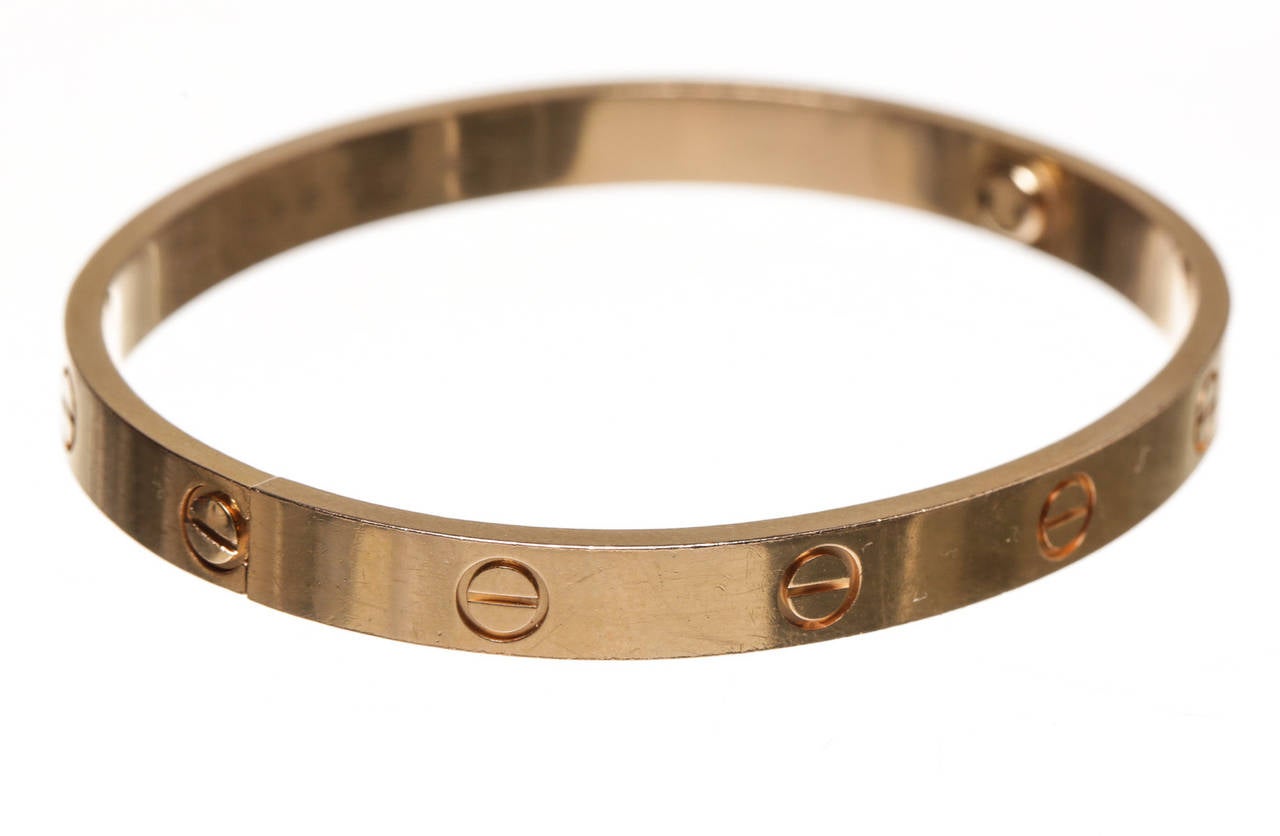 Luxury and beauty meet with this adorable Cartier Love Bracelet. Crafted from 18k rose gold, this bracelet features two screws and screw driver to open and close it. The Love collection has been popular with Cartier fans for years and you can