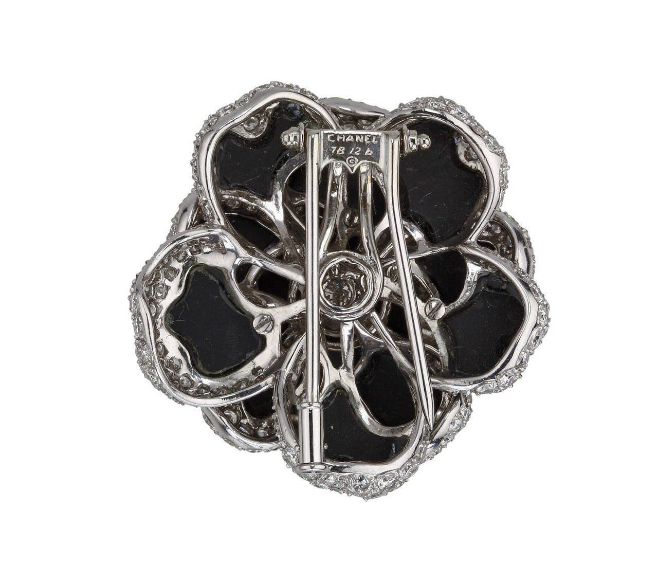 This fabulous onyx, diamond and white gold brooch by Chanel is a must have. It features flawlessly sculpted three layers of petals and diamonds throughout. The black onyx ensures it will compliment any outfit.