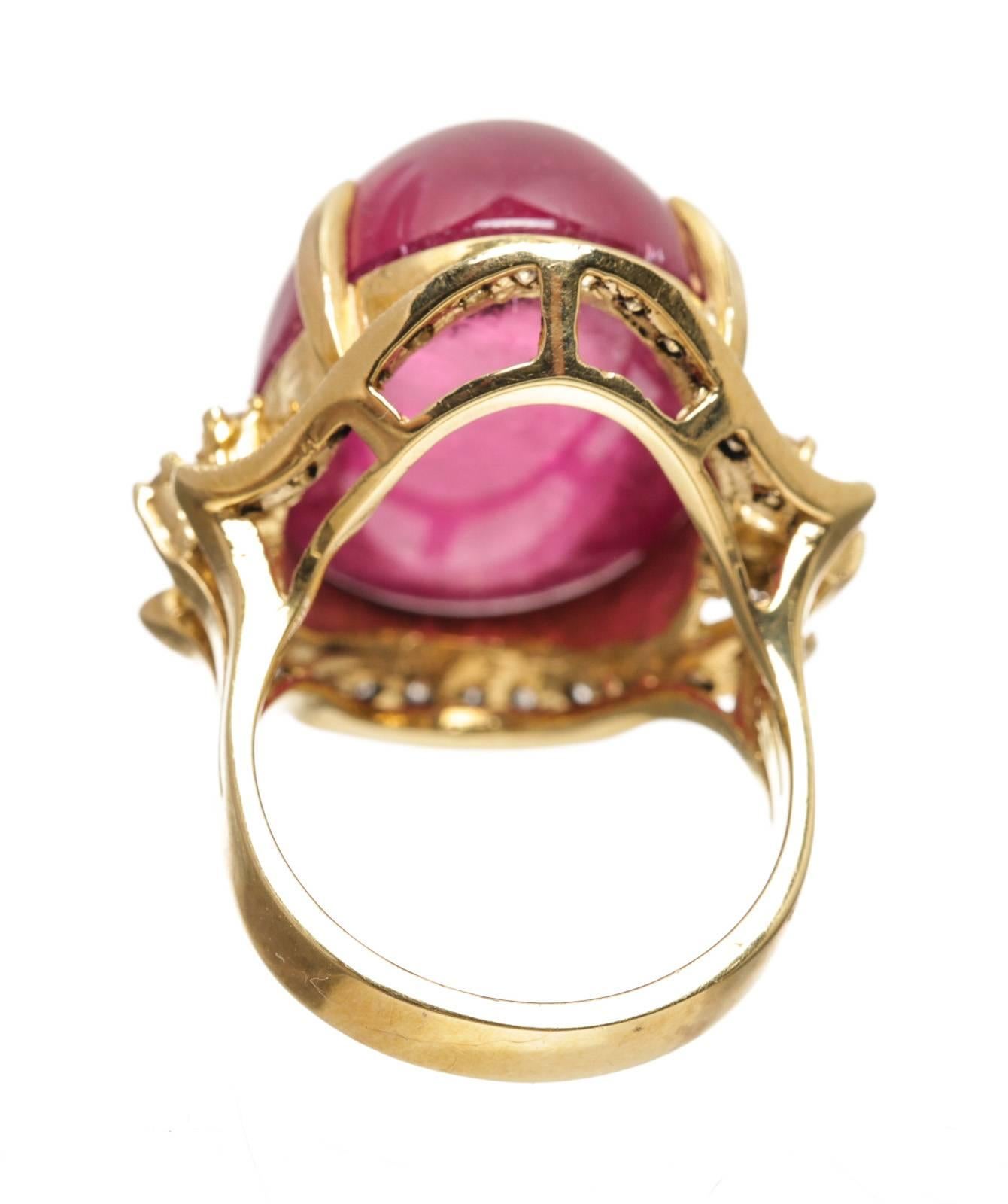 Crafted from 18k yellow gold, this ring is surrounded by diamonds and a large tourmaline .The tourmaline weighs approximately 35 carats.  Approximately .75 carats of diamonds.