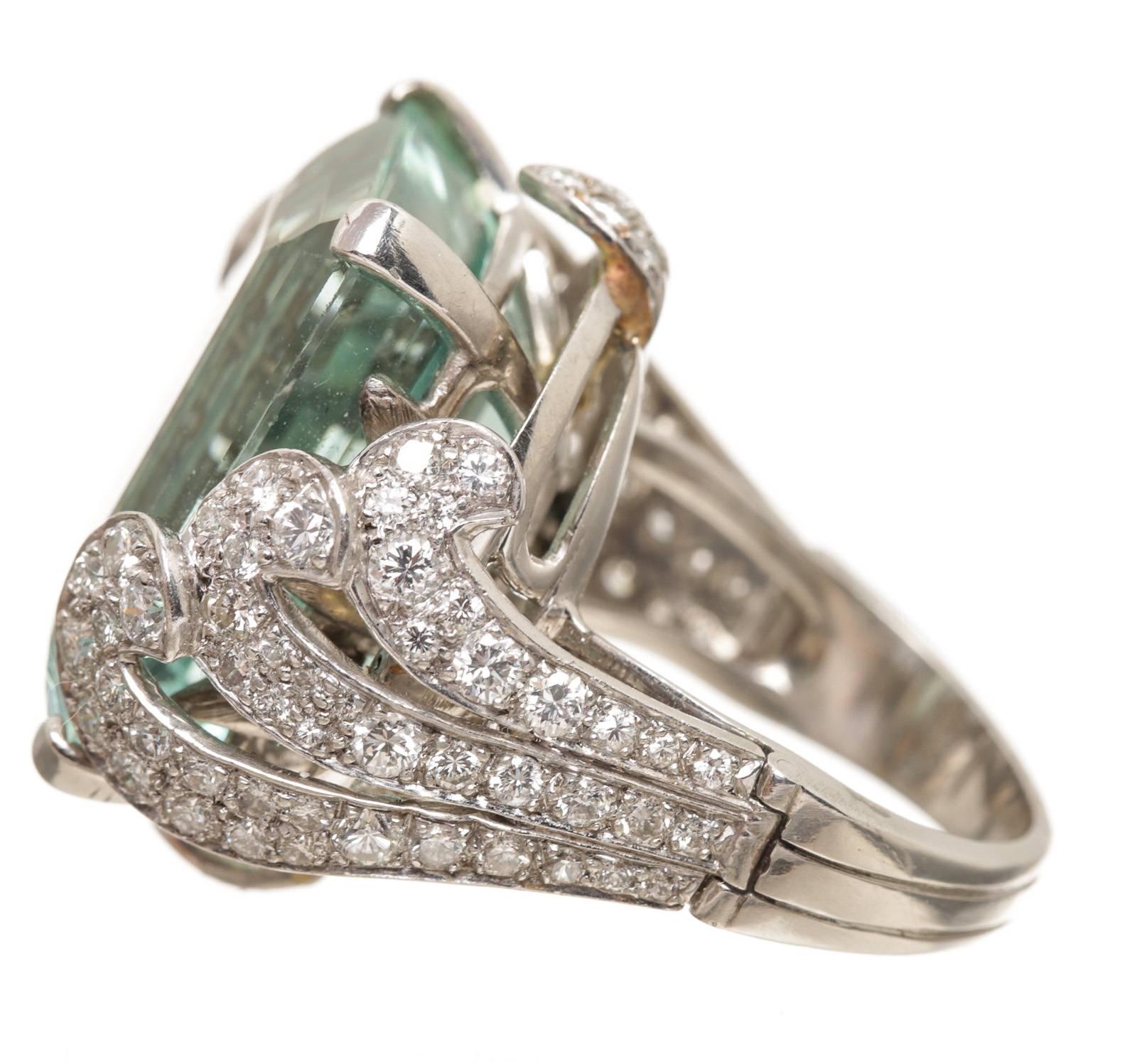 Crafted from platinum, this ring is surrounded by diamonds and a large aquamarine.The aquamarine weighs approximately 27 carats.  Approximately 2.75 carats of diamonds.
