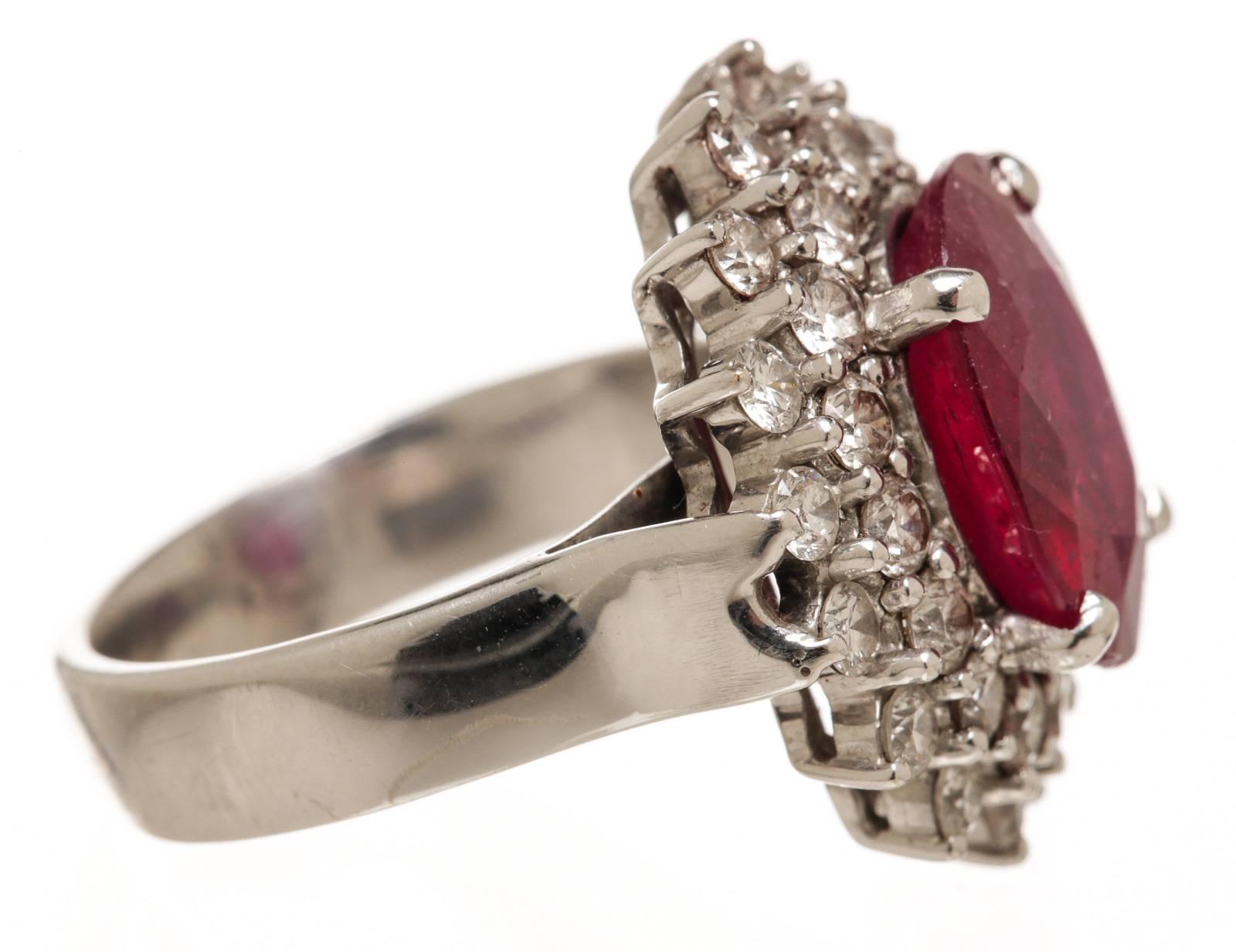 Add a stunning shimmer to your finger with this sparkling diamond ring, prong set with 32 round brilliant diamonds with SI1 clarity and H color. There is also one oval faceted glass filled ruby. It contains a traditional style with a bright finish,