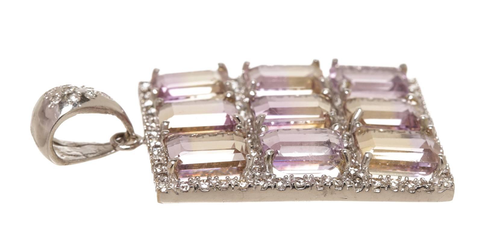 Featured here is this gorgeous 18k White Gold, Ametrine, and Diamond Pendant. This pendant weighs approximately 11.7 grams and is custom cast. It is styled in a traditional style with a bright finish. It measures approximately 42mm x 24mm. Prong set