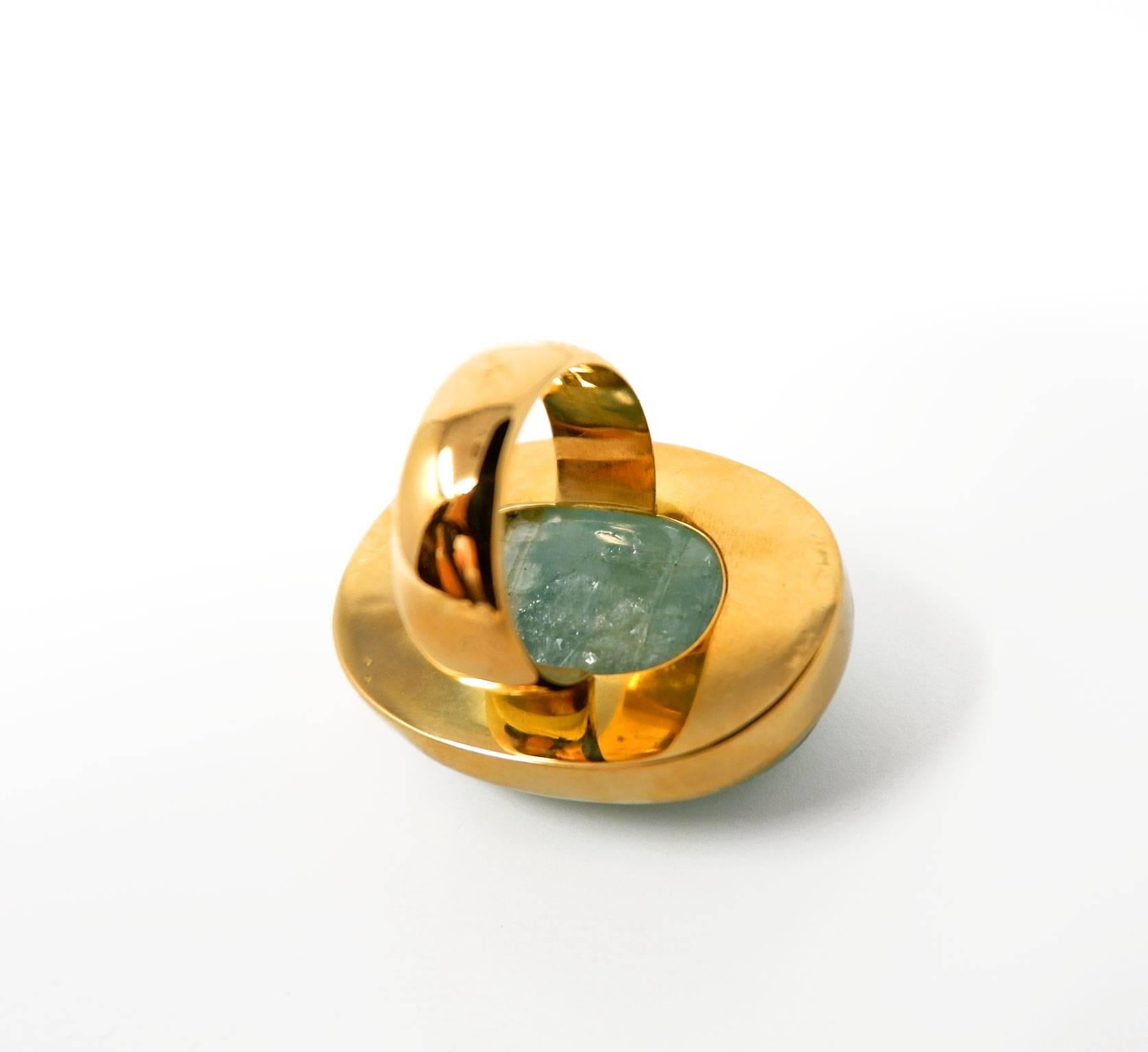 A spectacular 18 karat gold ring with a giant Indian carved aquamarine featuring a floral motif.  The exquisite art of gem carving has formed a part of India's cultural heritage for centuries. In this jewel this ancient tradition is fused with a