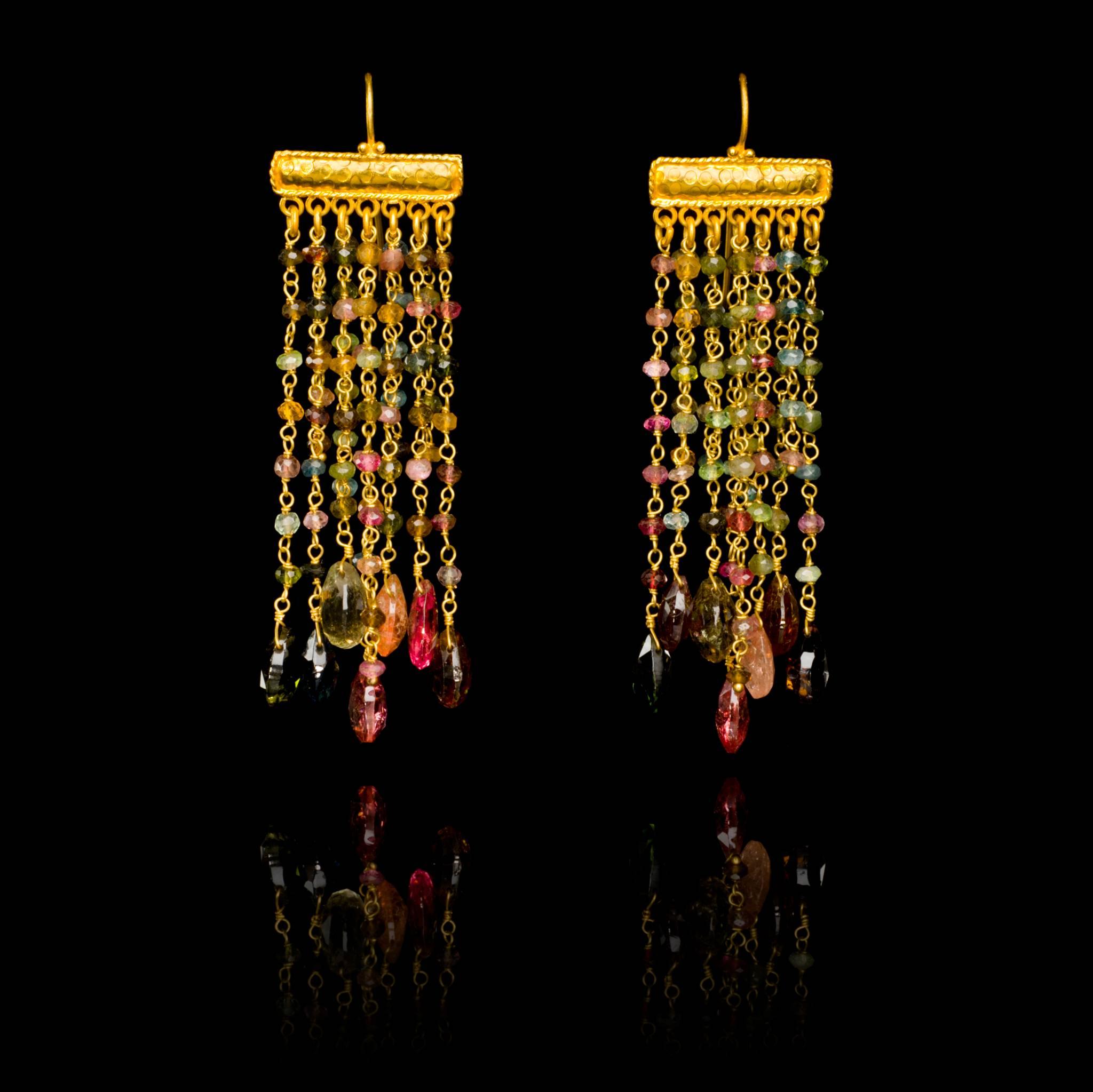 Hand embossed 18 karat gold chandelier earrings with tourmaline beads and briolettes. Due to the hand crafted nature of these jewels, slight asymmetry may occur. The earrings are 8cm, 3.13in long and 2cm, 0.75in wide. The weight of each earring is