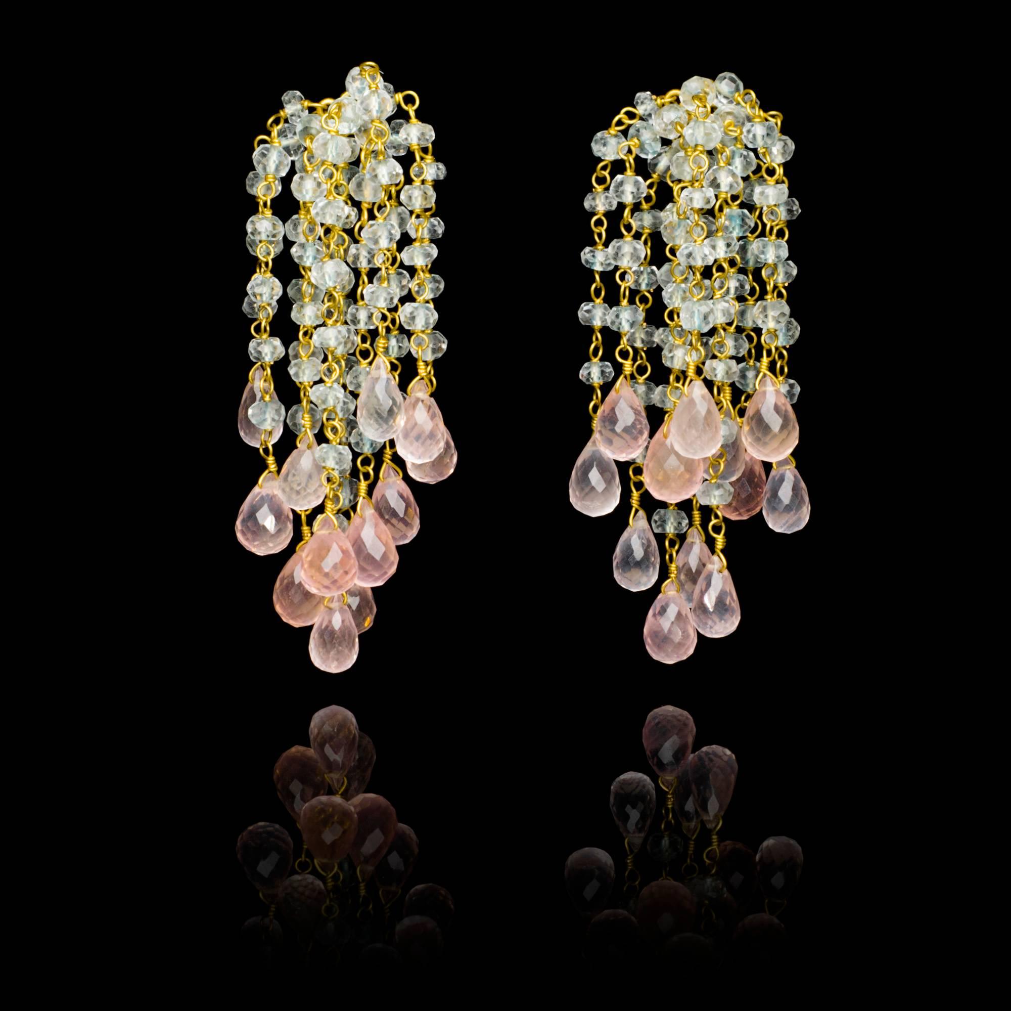A pair of elegant and playful hand crafted 18 karat gold Waterfall Earrings with light blue faceted aquamarine beads that look gorgeous next to the delicate pink of the rose quartz briolettes. These earrings would look just as good with a pair of