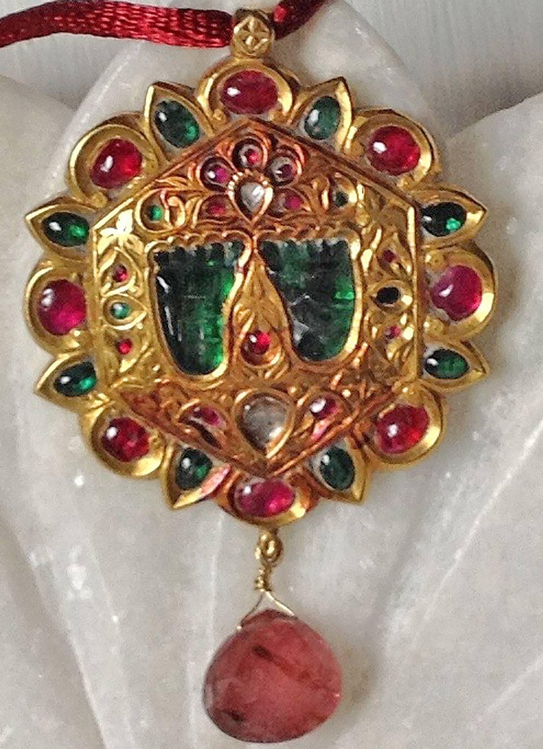 A charming hand made pendant created using traditional Rajasthani techniques. Flat cut foiled backed diamonds, natural rubies. The green stones are probably quartz which have been backed with green foil. The pendant features a delightful pair of 